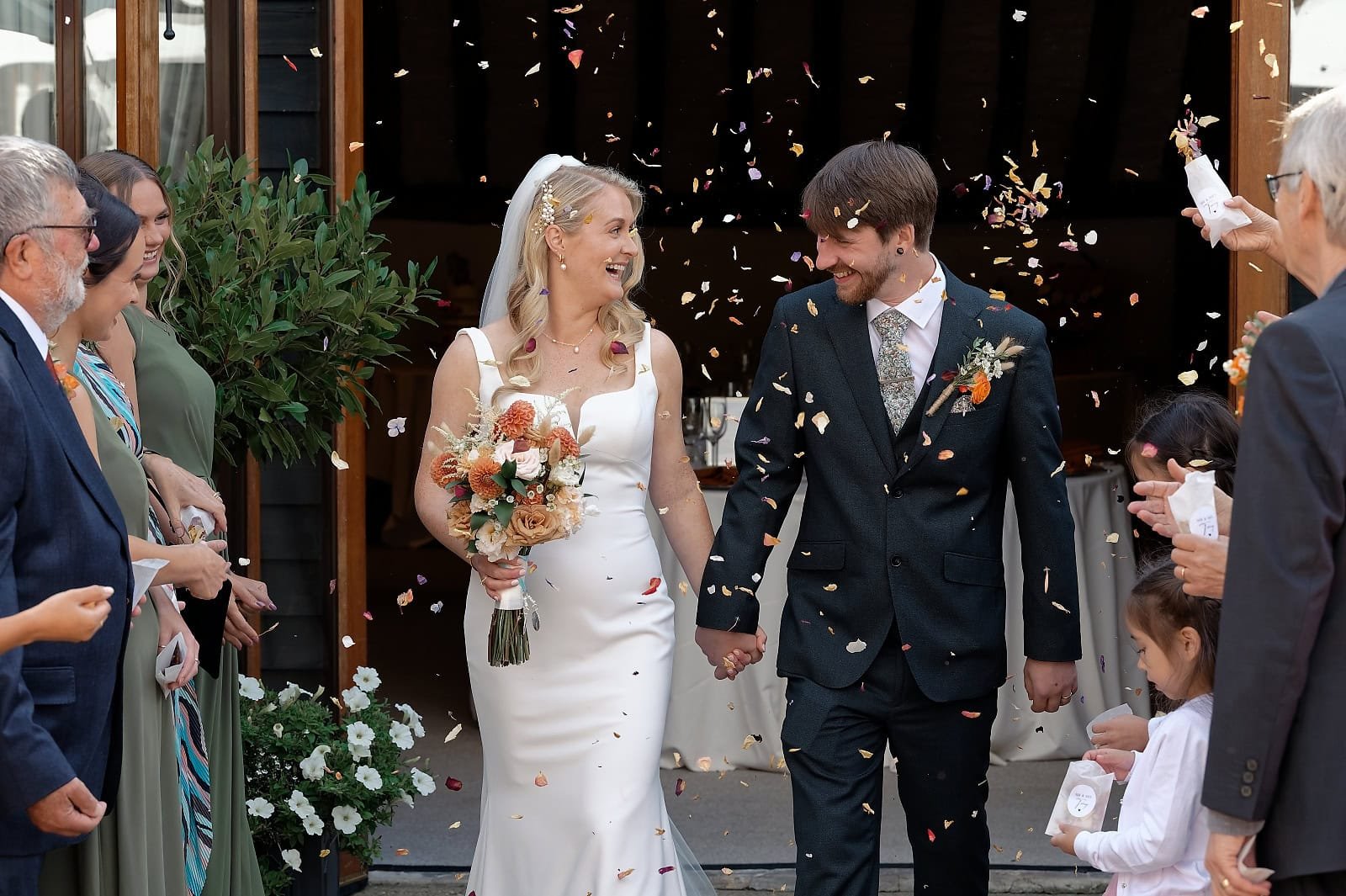 Confetti exit for the bride and groom in the courtyard at Fitzleroi Barn