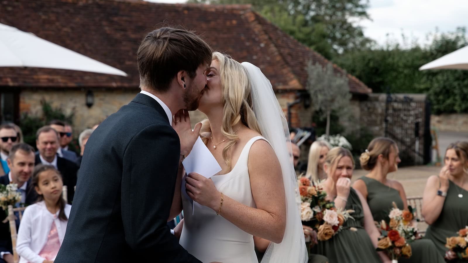 Bride and groom share their first kiss as a married couple at Fitzleroi Barn