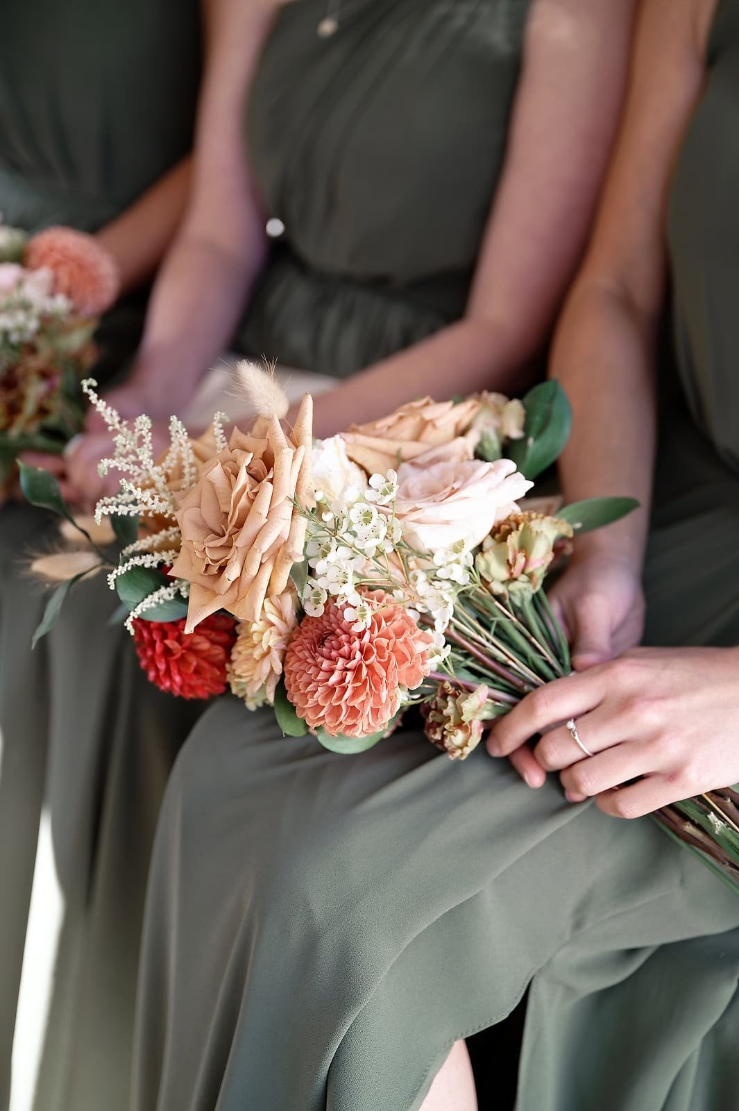 Detail of an autumn-toned wedding bouquet with dahlias and roses at a Fitzleroi Barn wedding