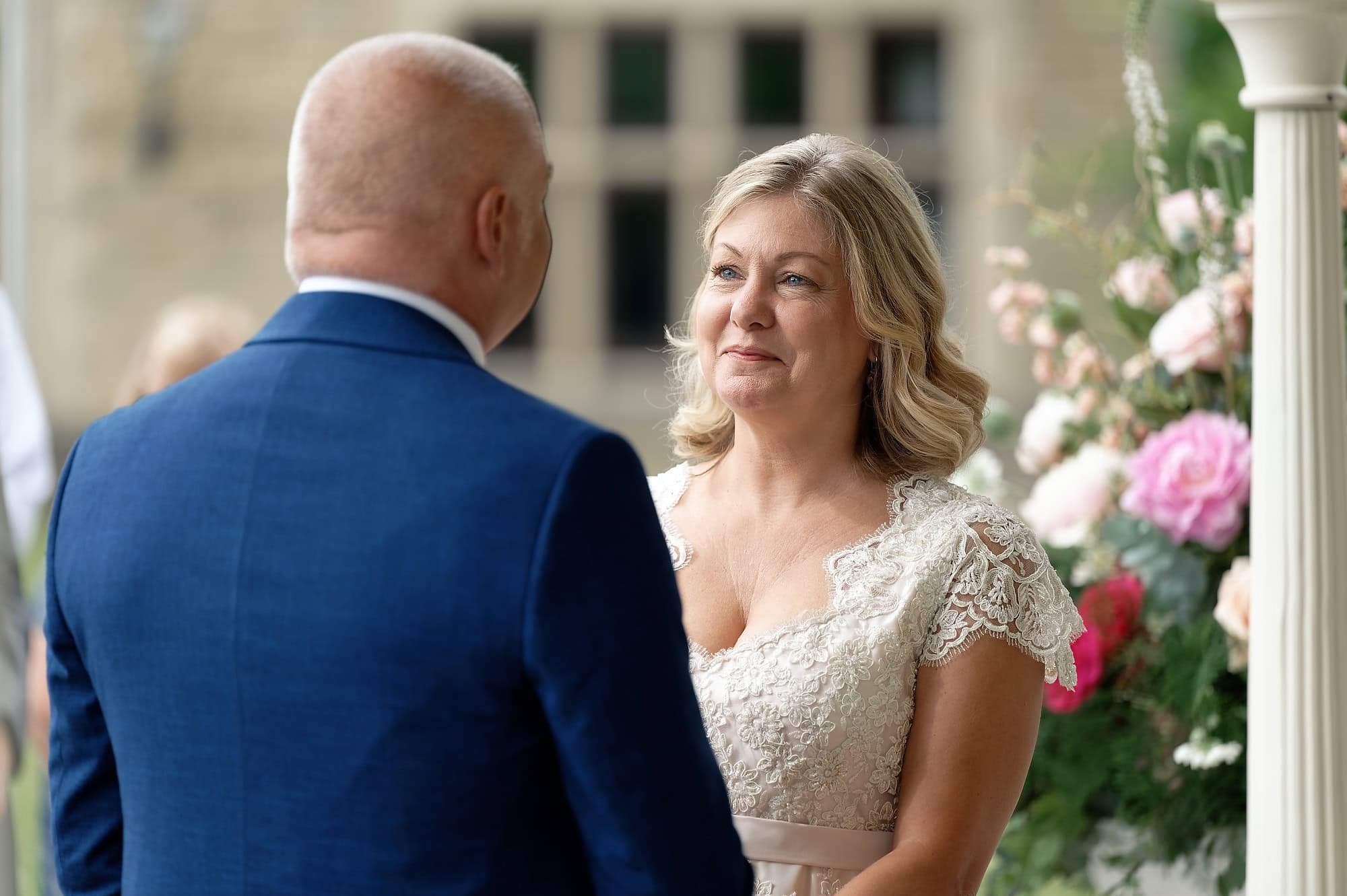 Bride looking lovingly at the groom during their outdoor wedding ceremony at the Pavilion, South Lodge, Horsham