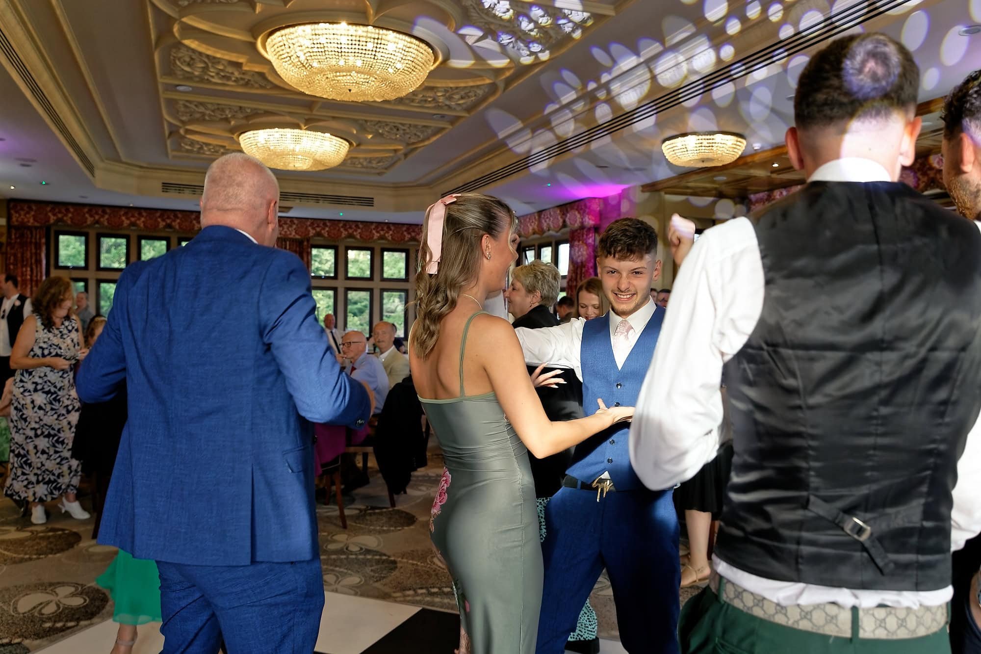 bride and groom's son having fun on the dance floor at South Lodge Hotel wedding reception, Horsham, West Sussex