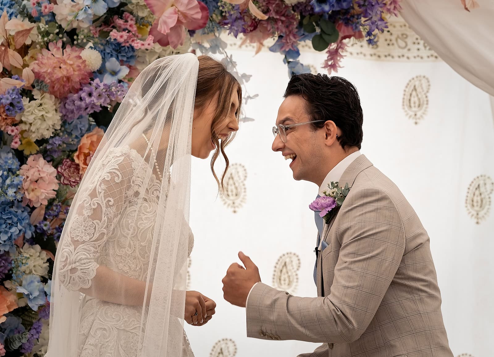 Bride and groom laughing during wedding ceremony at Trading Boundaries Sussex