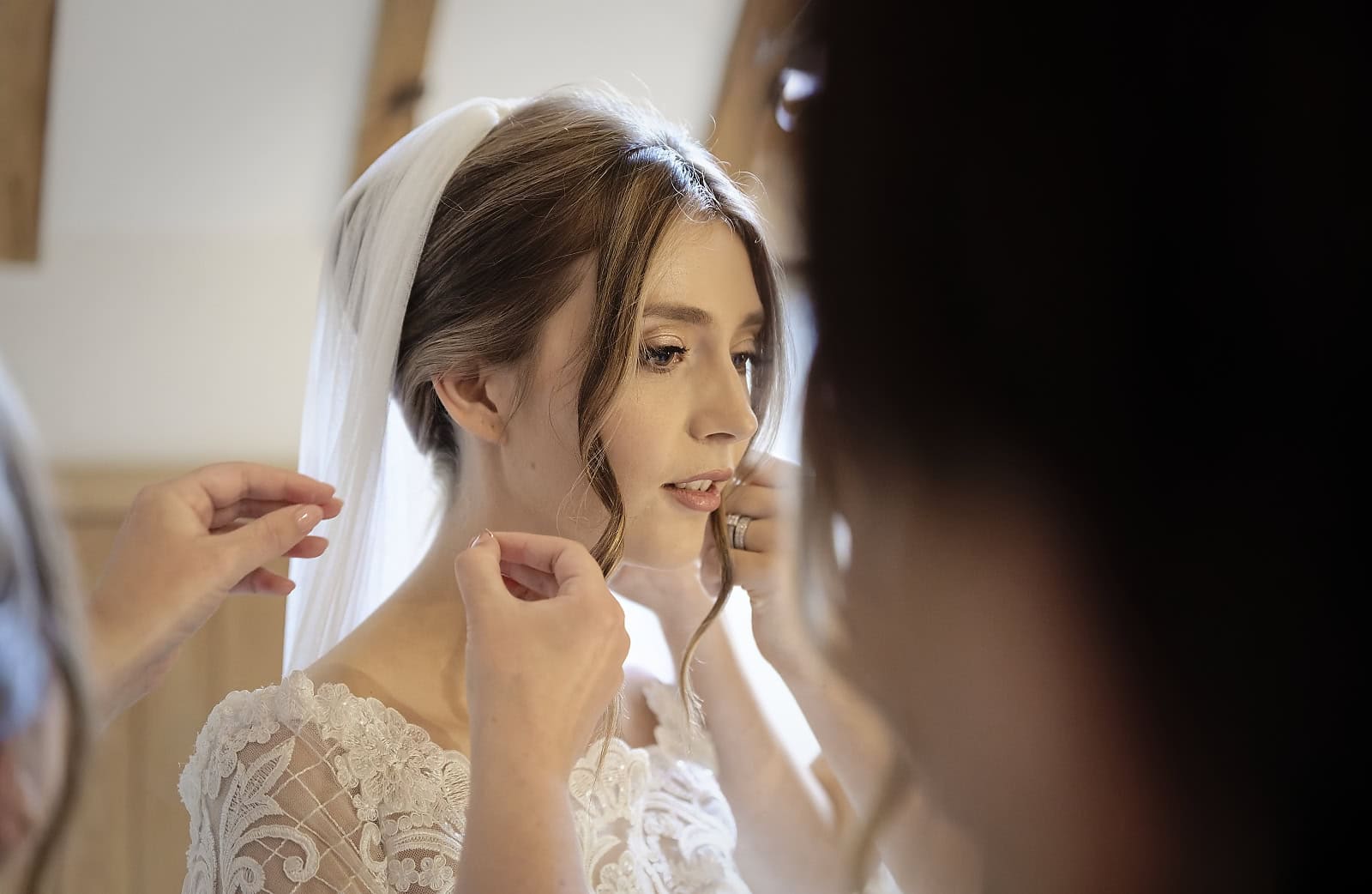 Bride getting ready with bridesmaids in light filled room at Trading Boundaries wedding venue
