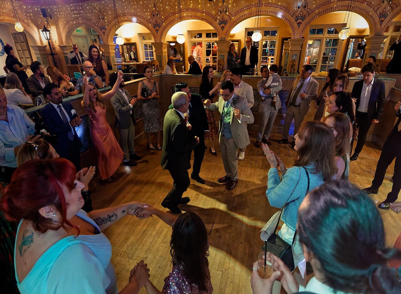 Wide angle of busy dance floor at Trading Boundaries evening reception
