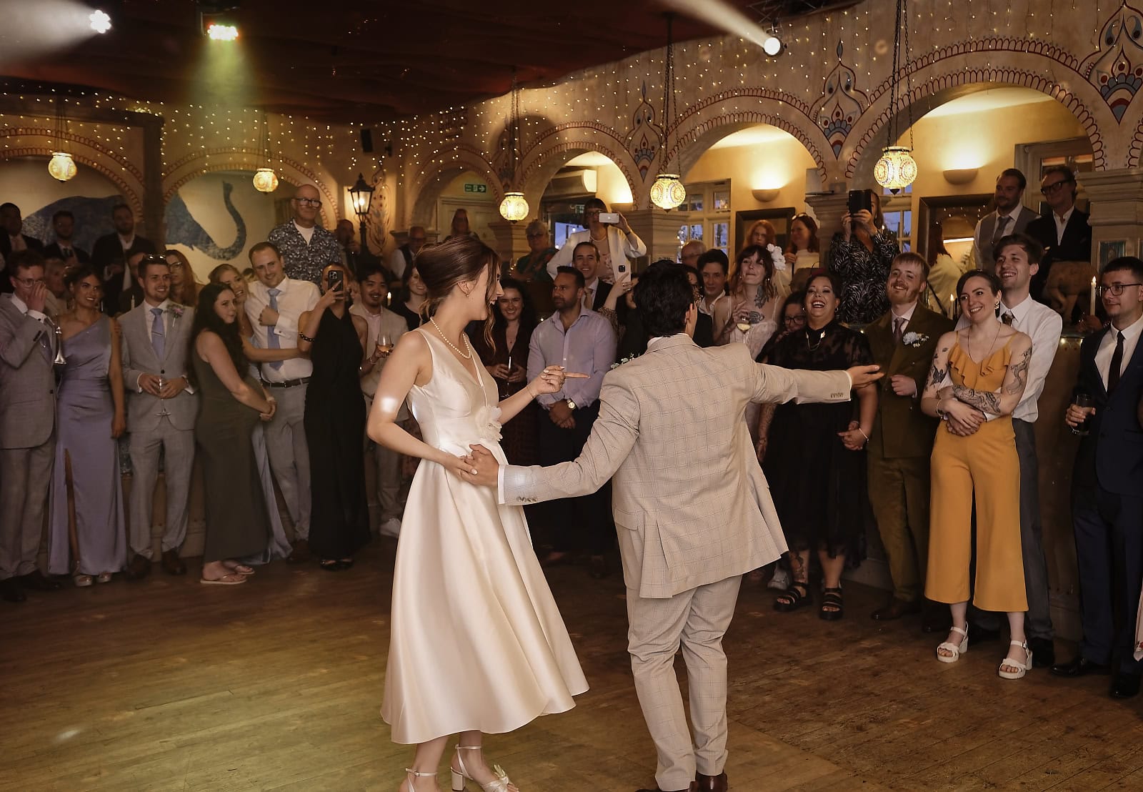 Wedding guests enjoying evening reception inside Trading Boundaries Sussex
