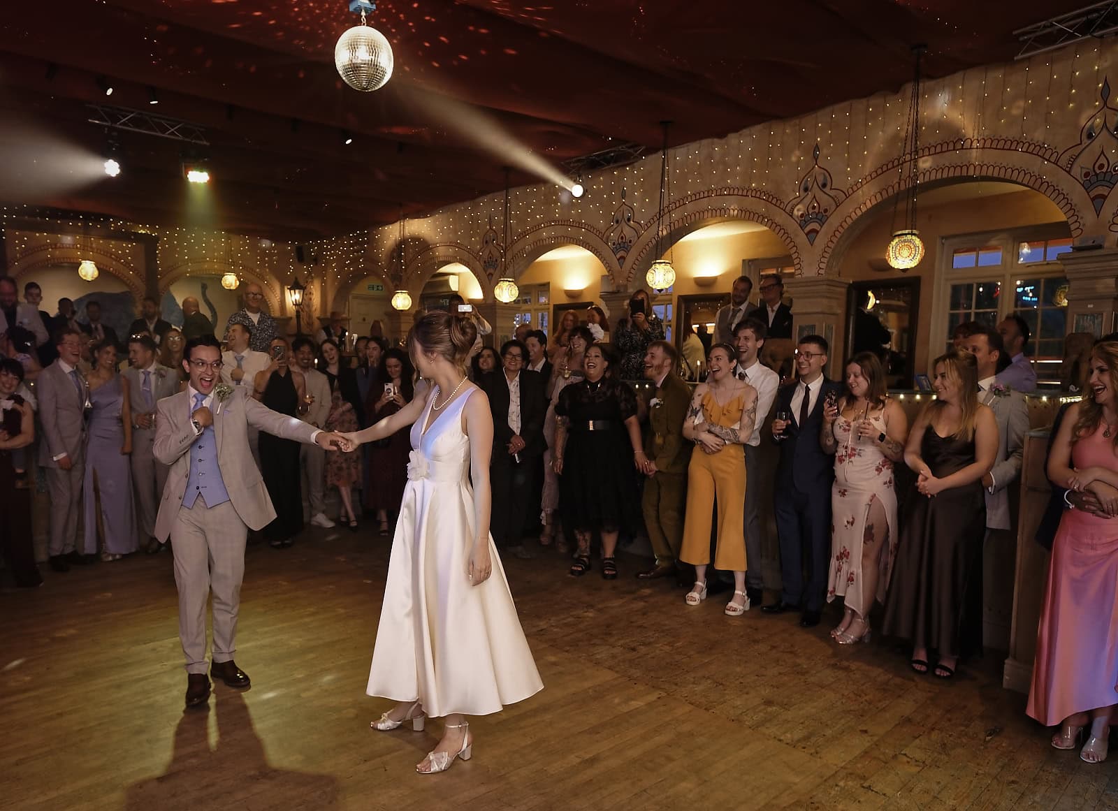 Bride and groom first dance surrounded by guests at Trading Boundaries