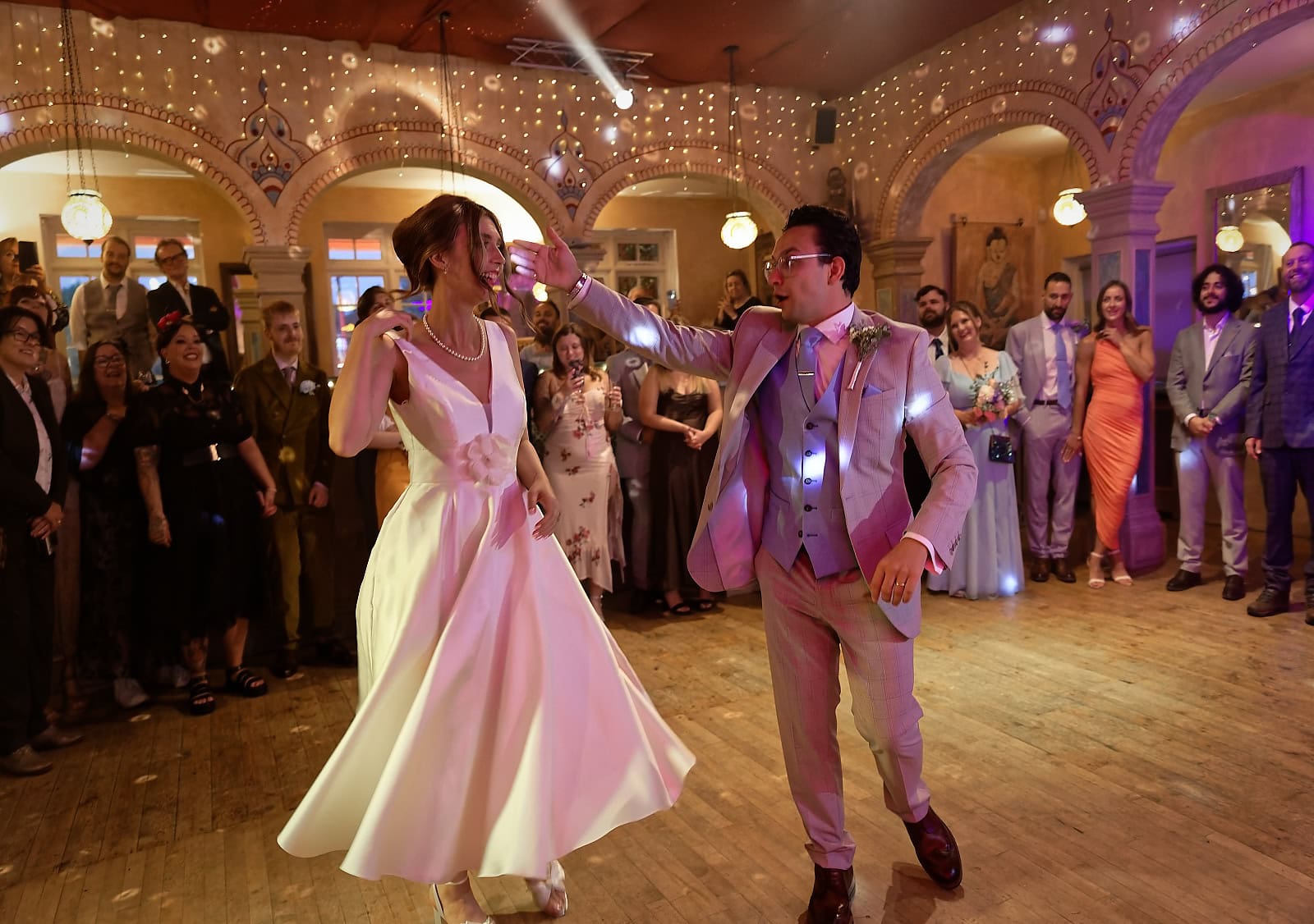 Bride spinning during first dance with groom at Trading Boundaries wedding Sussex