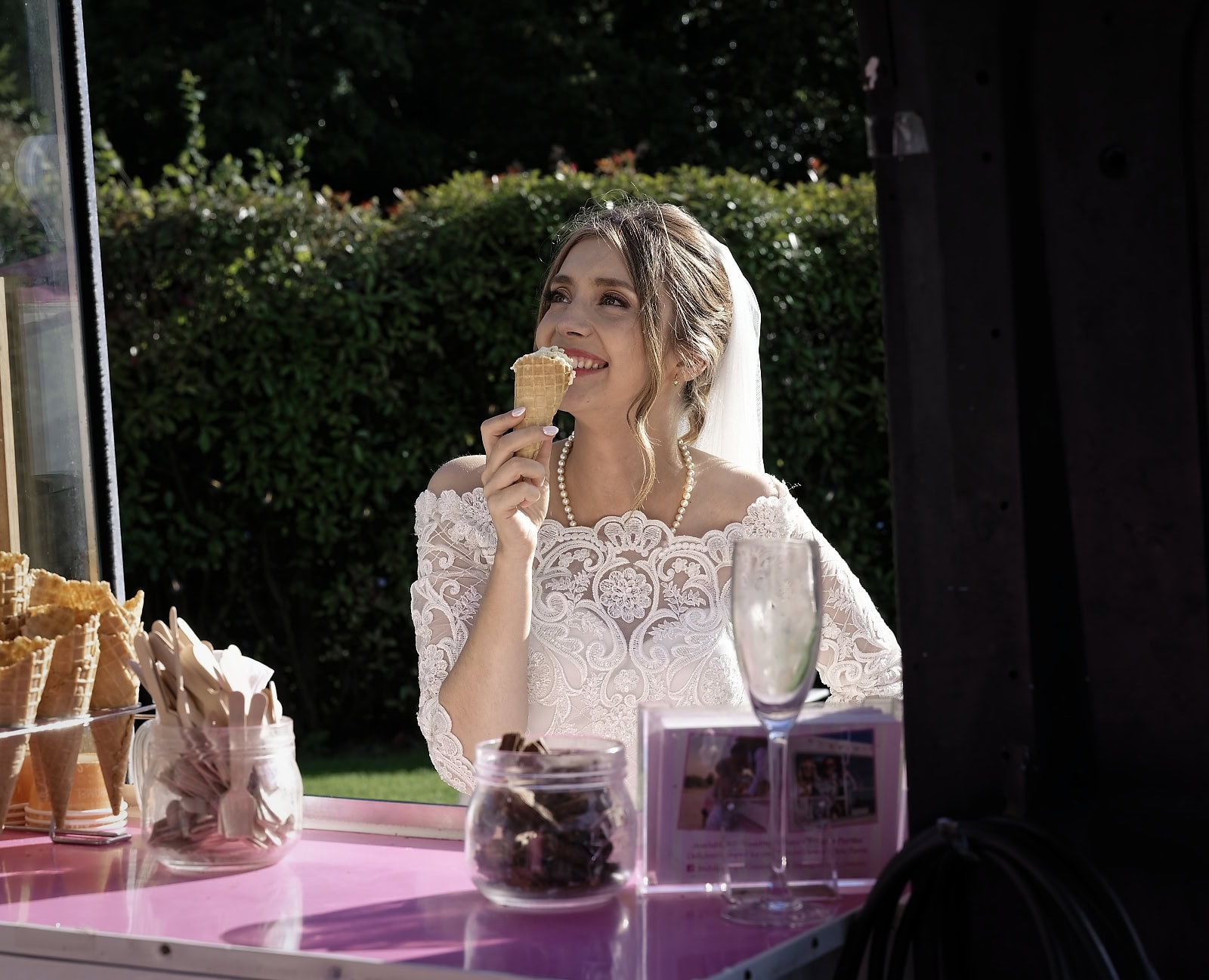 Bride eating ice cream at vintage van during Trading Boundaries wedding Sussex