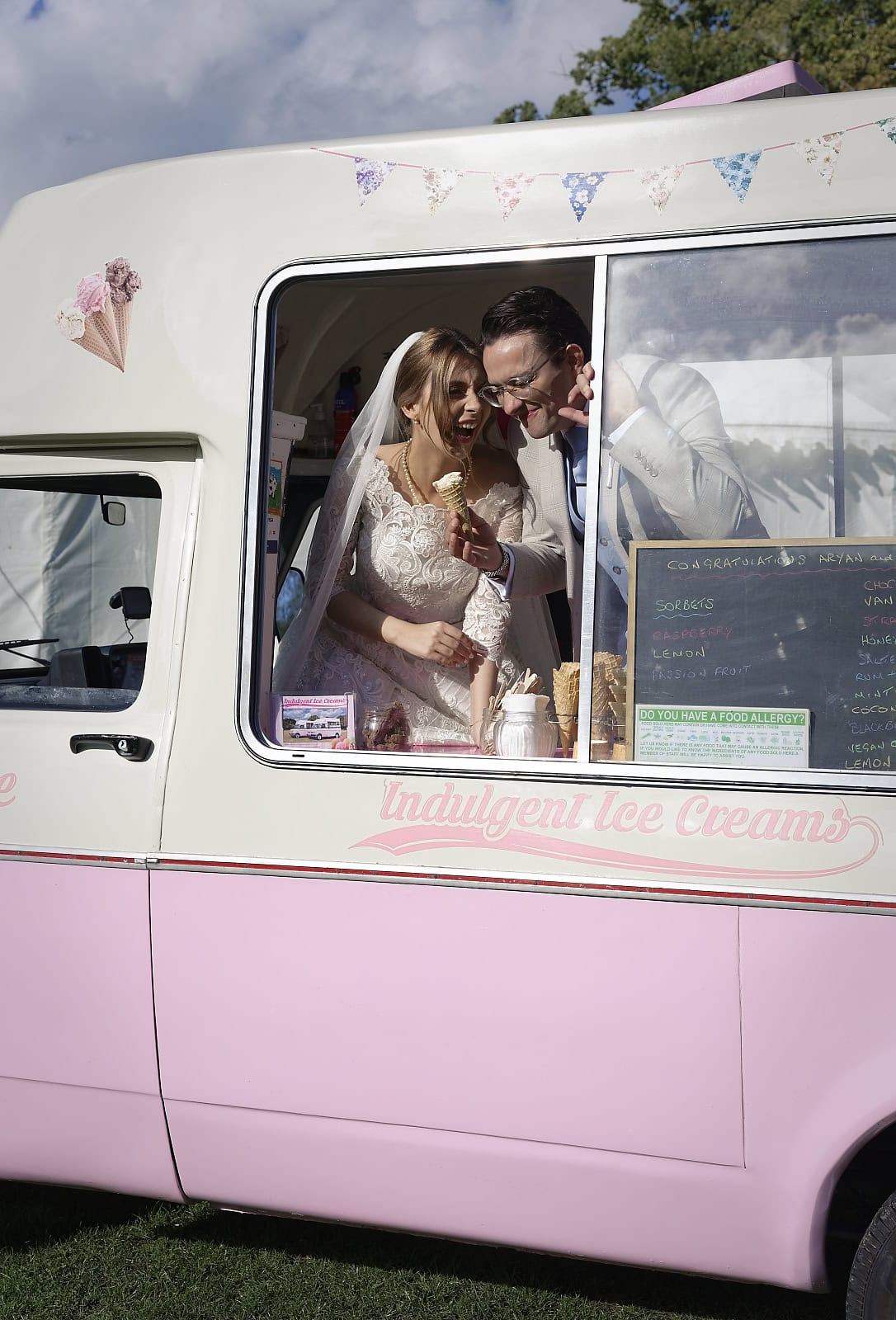 Bride and groom laughing while eating ice cream at Sussex wedding reception