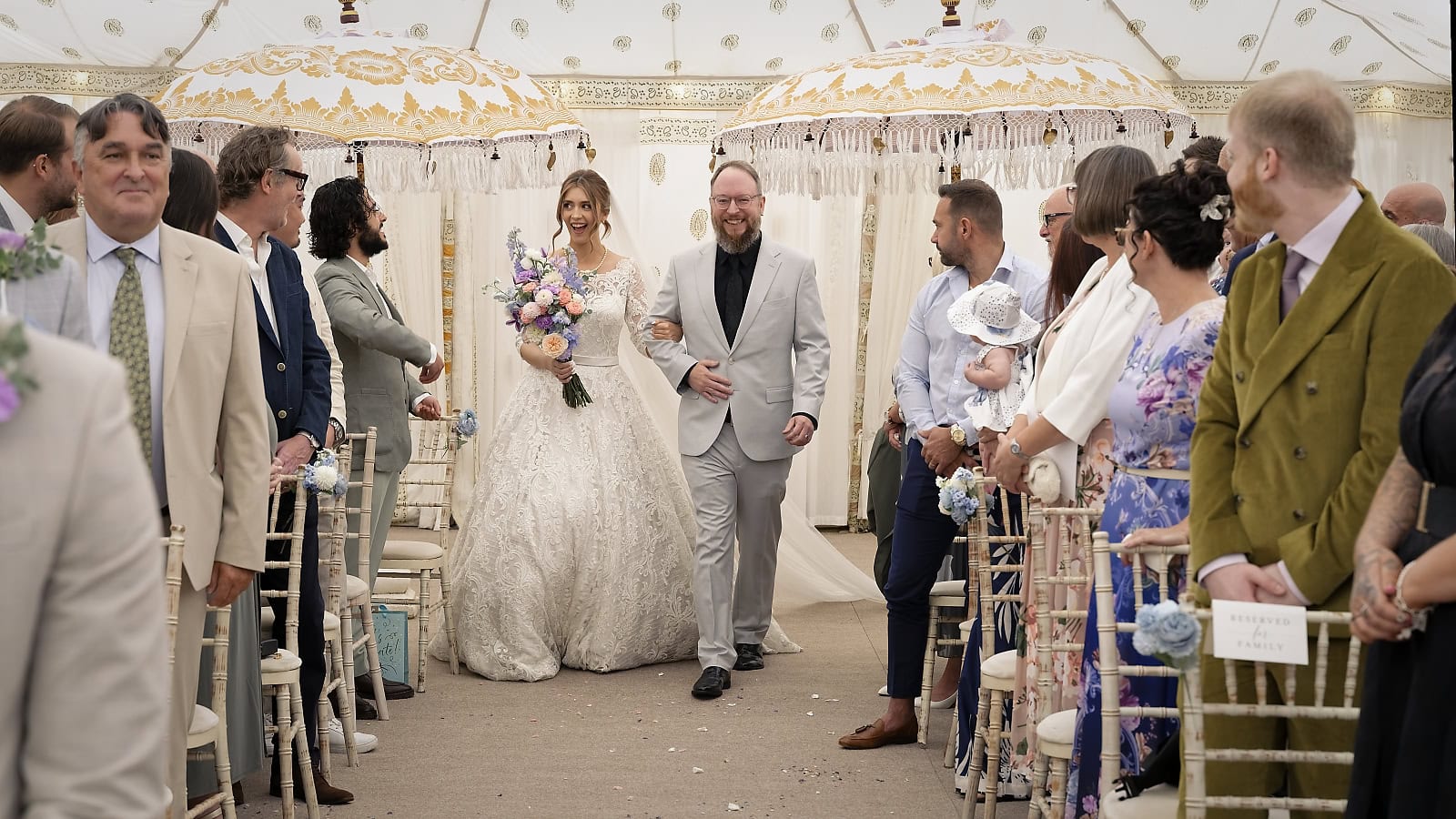 Bride walking down aisle with her father at Trading Boundaries wedding venue