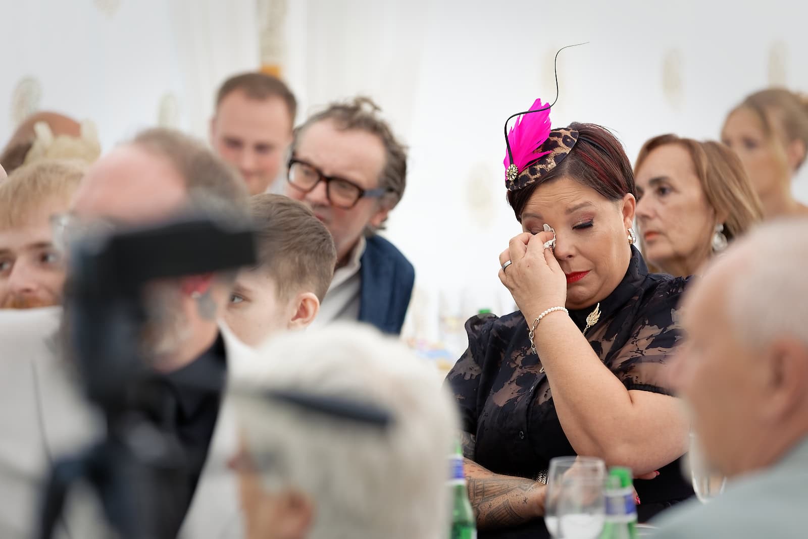 Wedding guest wiping away tears during emotional speech at Sussex wedding
