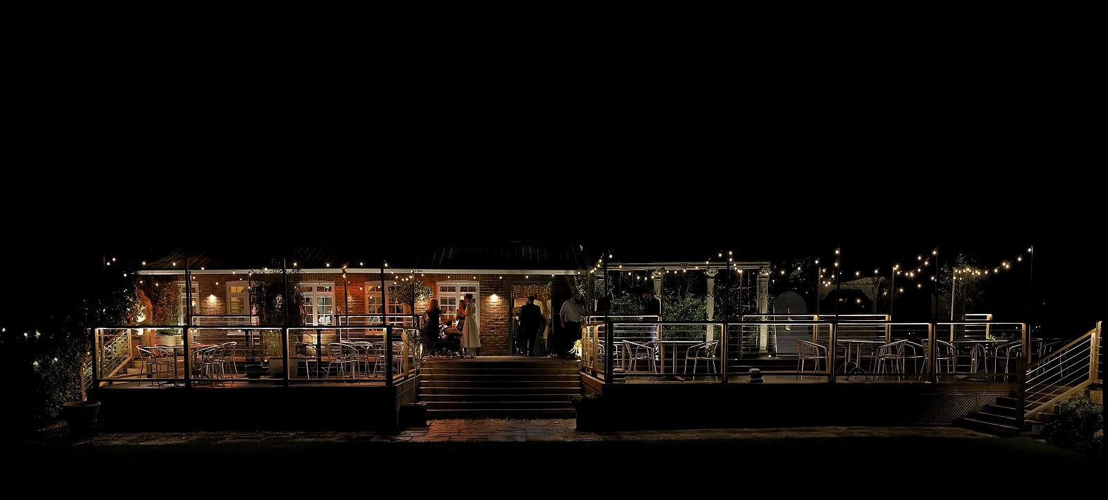 Trading Boundaries wedding venue at night with outdoor terrace and festoon lighting in Sussex