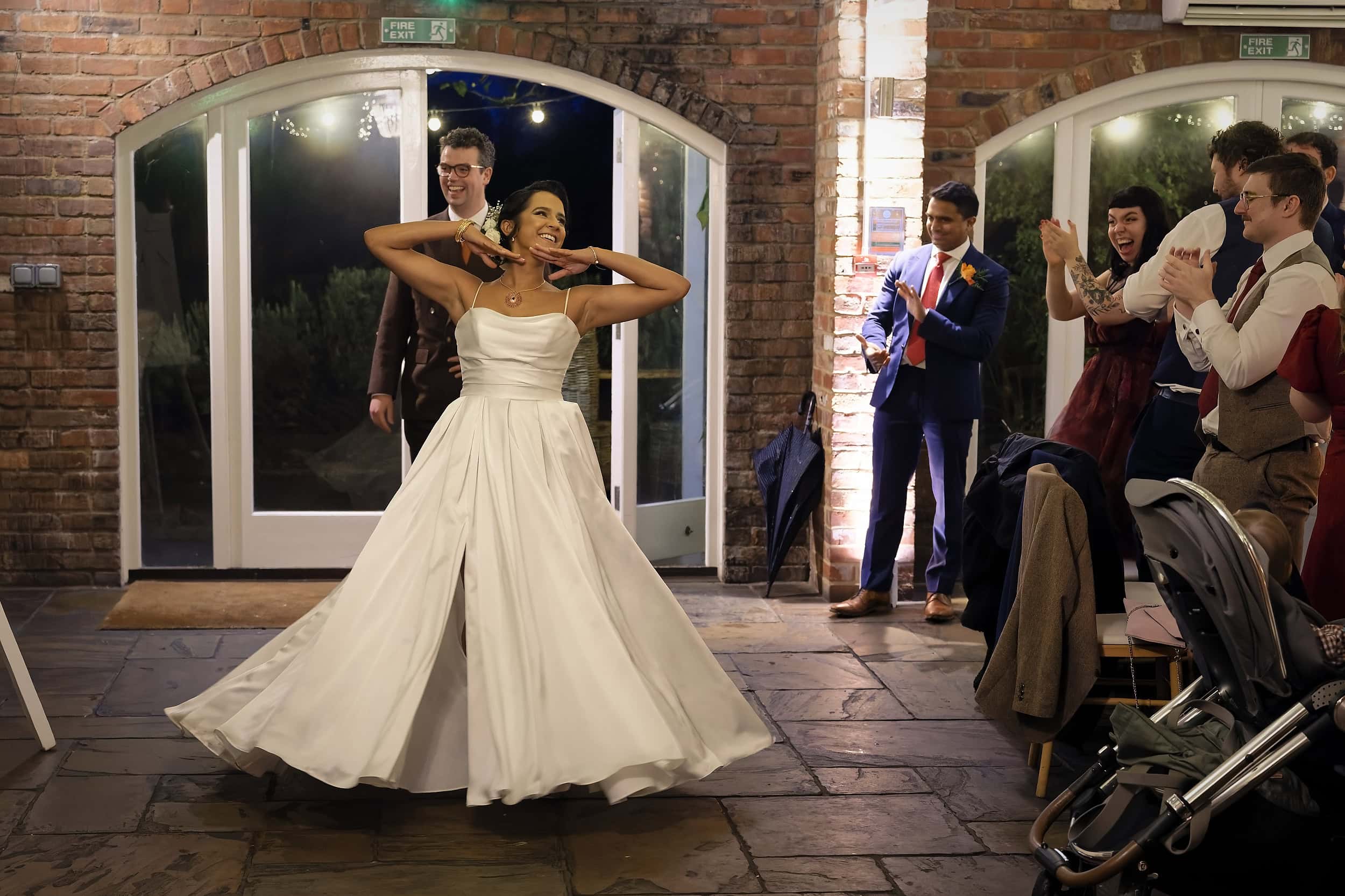 Bride making her entrance into the Orangery wedding breakfast at Northbrook Park wedding venue in Hampshire by Andy Kerr Photography