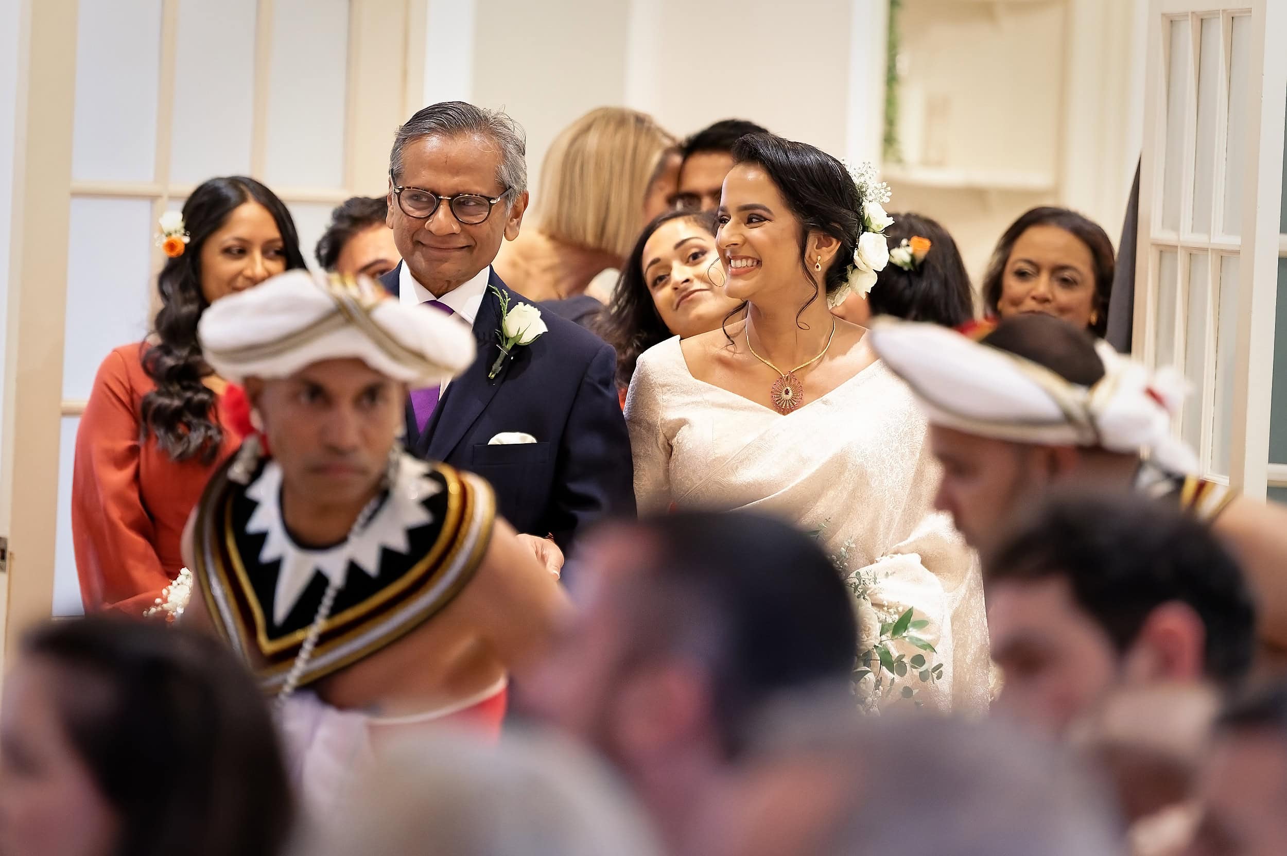 Bride walking down the aisle with her father during the ceremony procession in the Vine Room at Northbrook Park wedding venue in Hampshire by Andy Kerr Photography