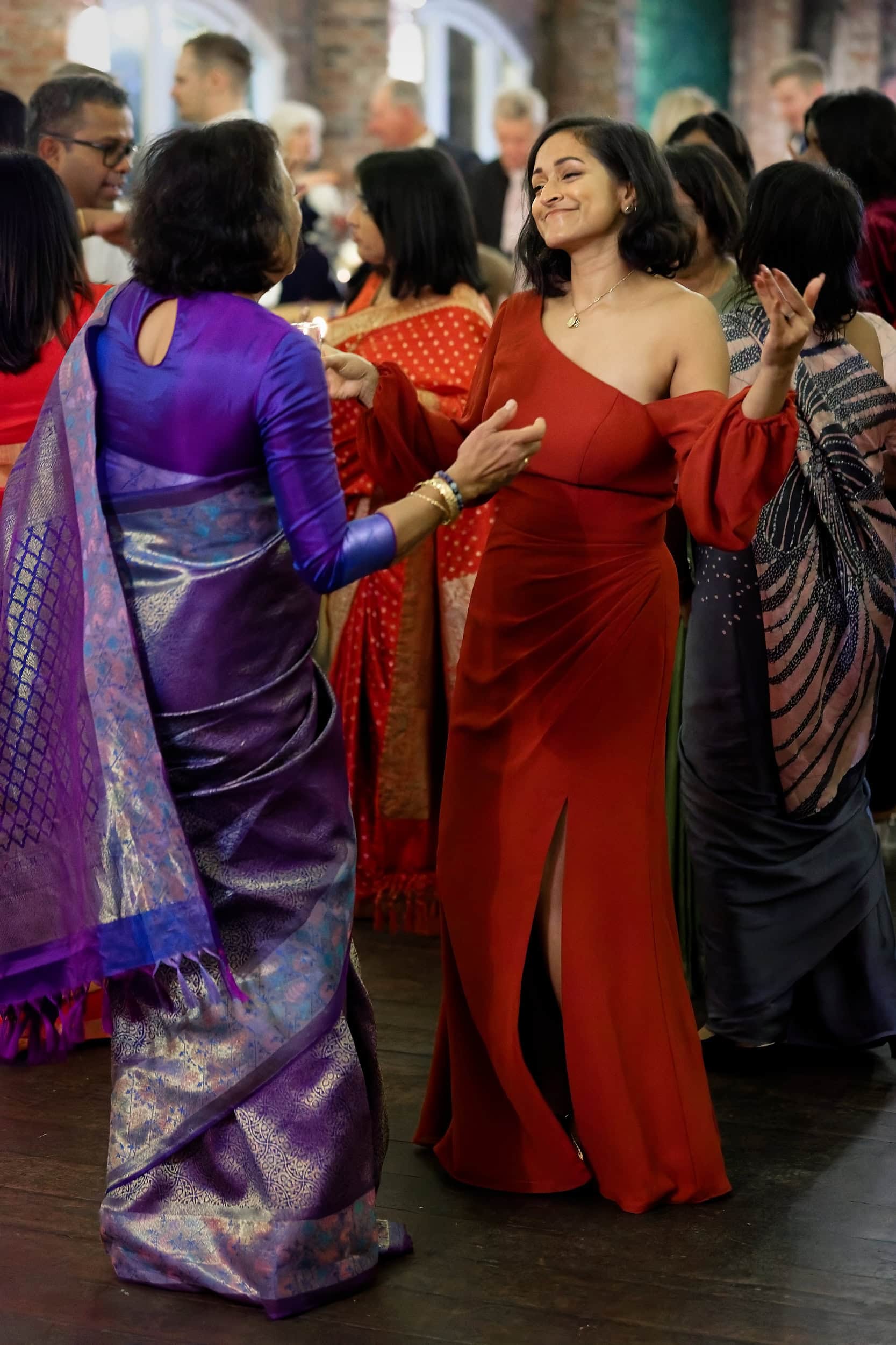Candid moment of guests dancing during the evening reception in the Orangery at Northbrook Park wedding venue in Hampshire by Andy Kerr Photography