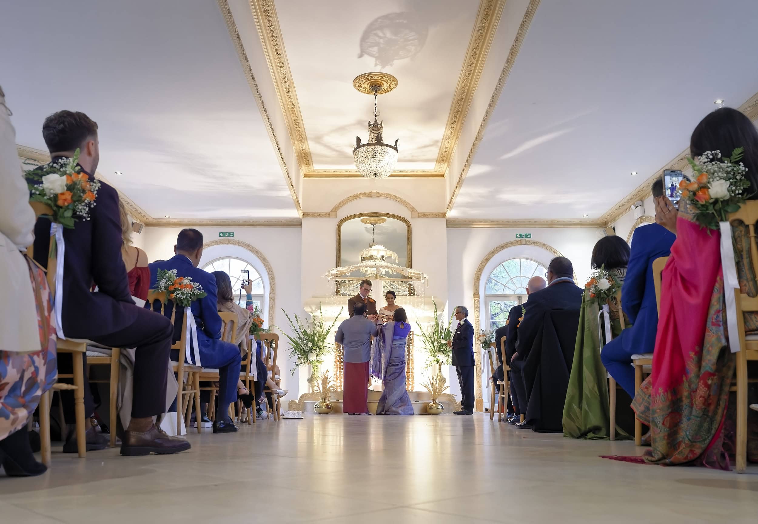 Bride and groom at the Poruwa during their wedding ceremony in the Vine Room at Northbrook Park wedding venue in Hampshire by Andy Kerr Photography