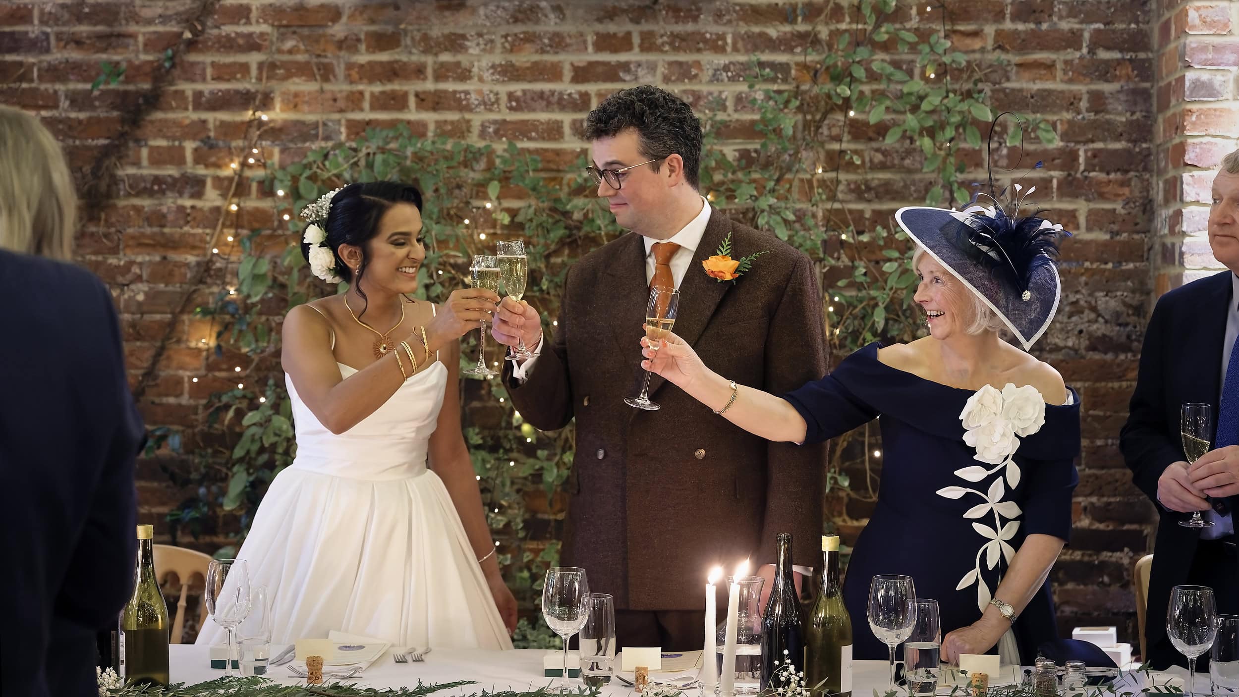 Bride and groom champagne toast during speeches in the Orangery at Northbrook Park wedding venue in Hampshire by Andy Kerr Photography
