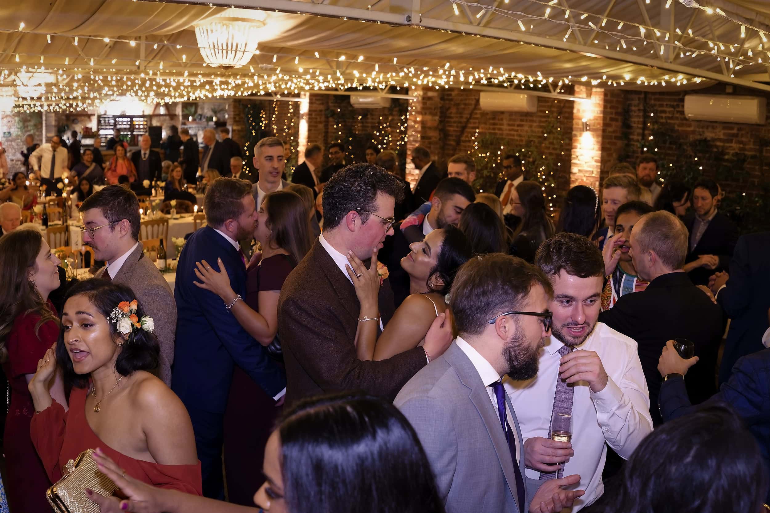 Packed dance floor during the evening reception in the Orangery at Northbrook Park wedding venue in Hampshire by Andy Kerr Photography