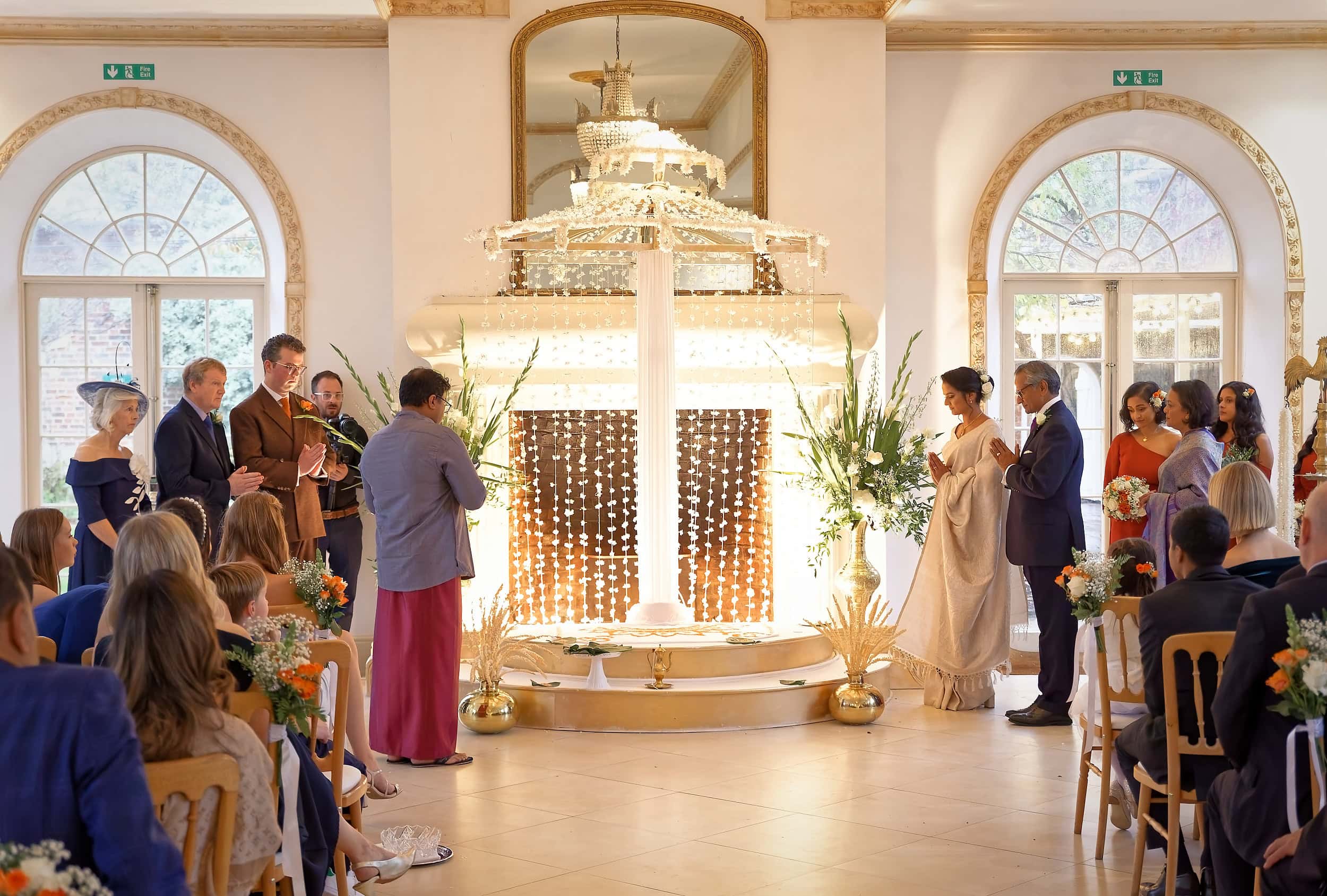 Wide view of bride and groom at the Poruwa during their wedding ceremony in the Vine Room at Northbrook Park wedding venue in Hampshire by Andy Kerr Photography