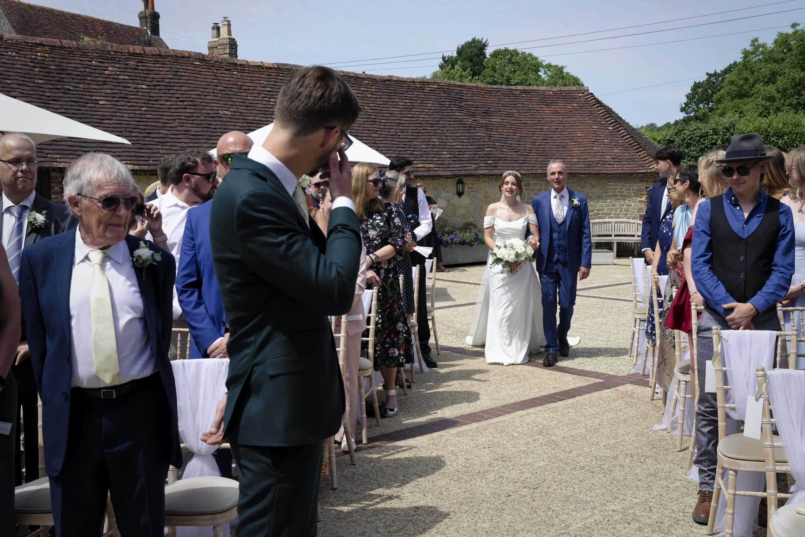 Fitzleroi Barn wedding photographer photo of the bride walking down the aisle with her father