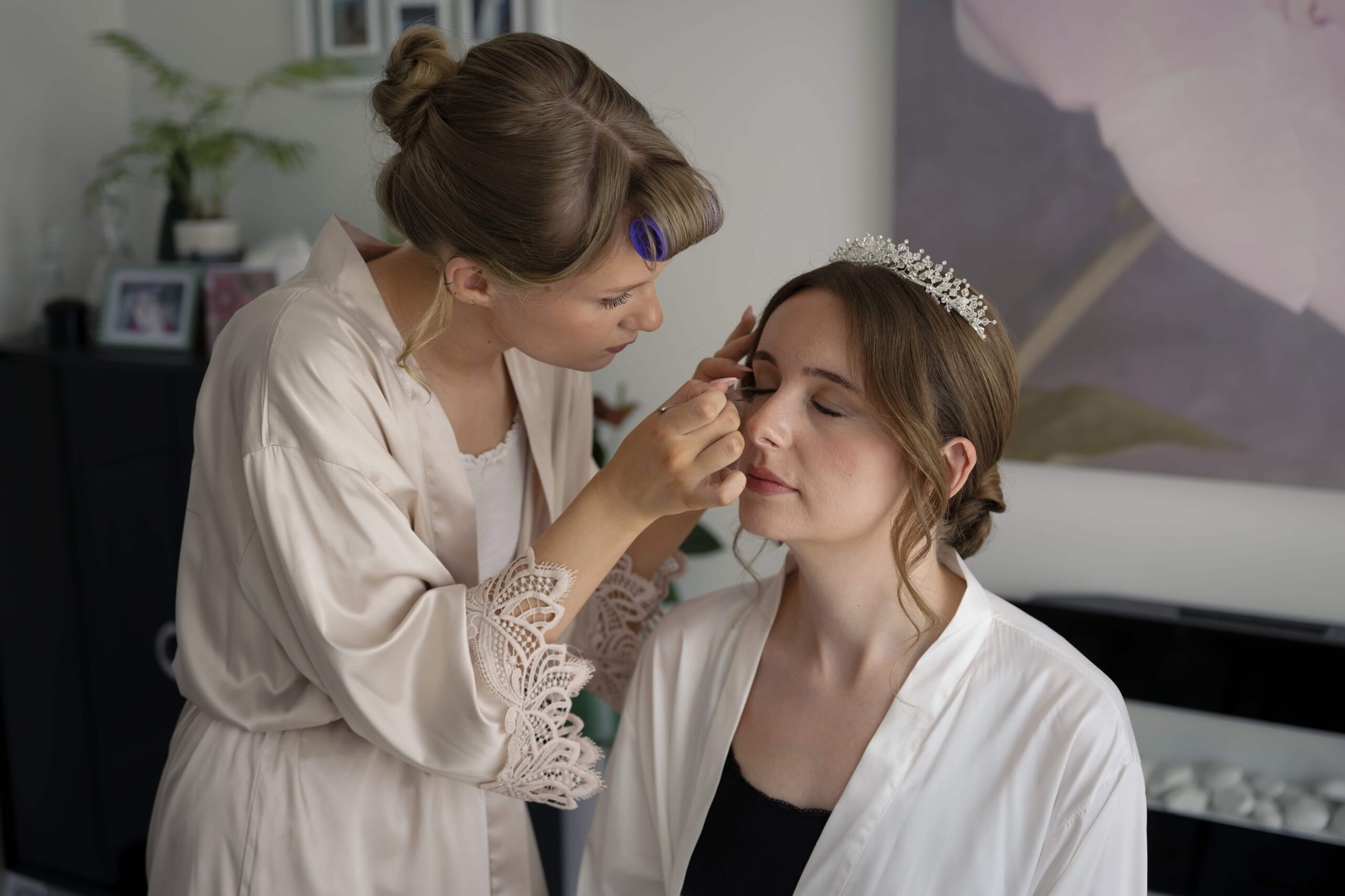 Fitzleroi Barn wedding photographer capturing the bride having her makeup and tiara finished before the ceremony