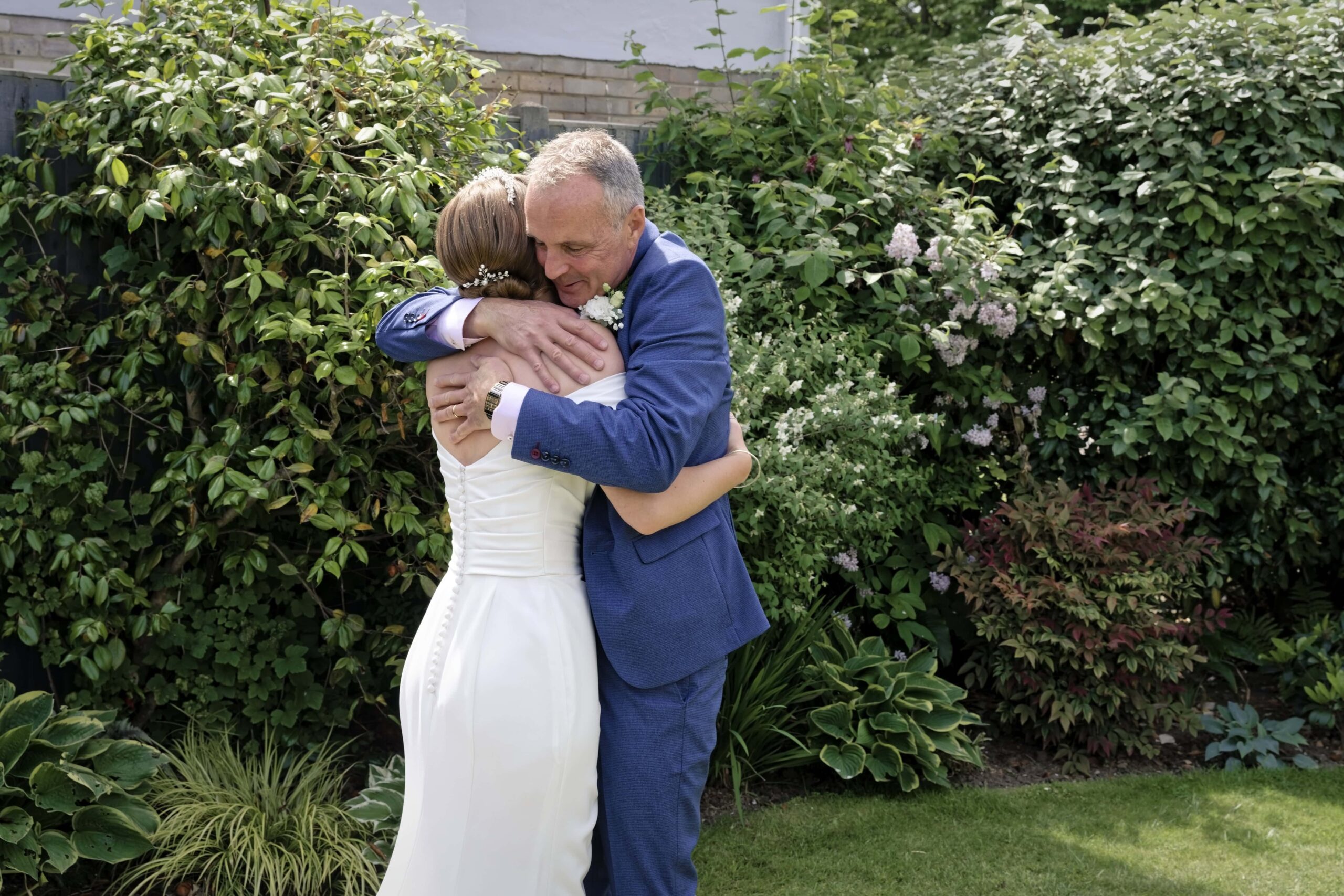 Fitzleroi Barn wedding photographer photo of a bride embracing her father before the wedding ceremony