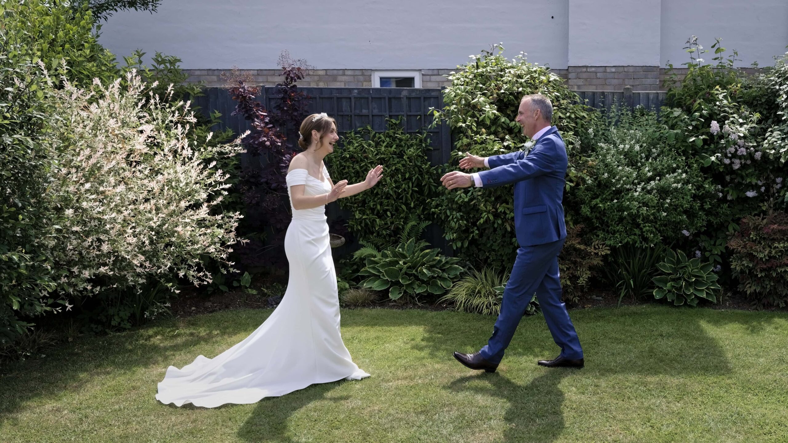 Fitzleroi Barn wedding photographer capturing the bride and her father's first look moment in the garden