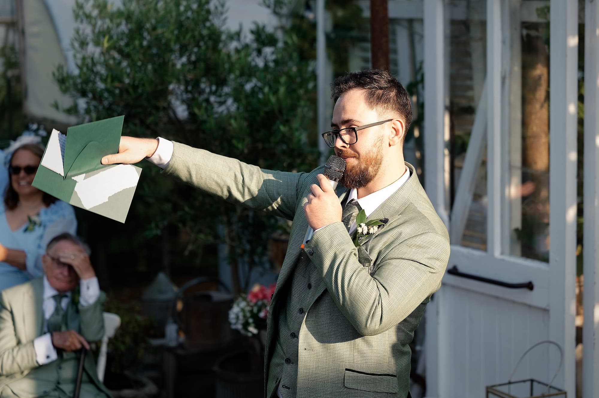 Best man giving an animated speech to the wedding guests