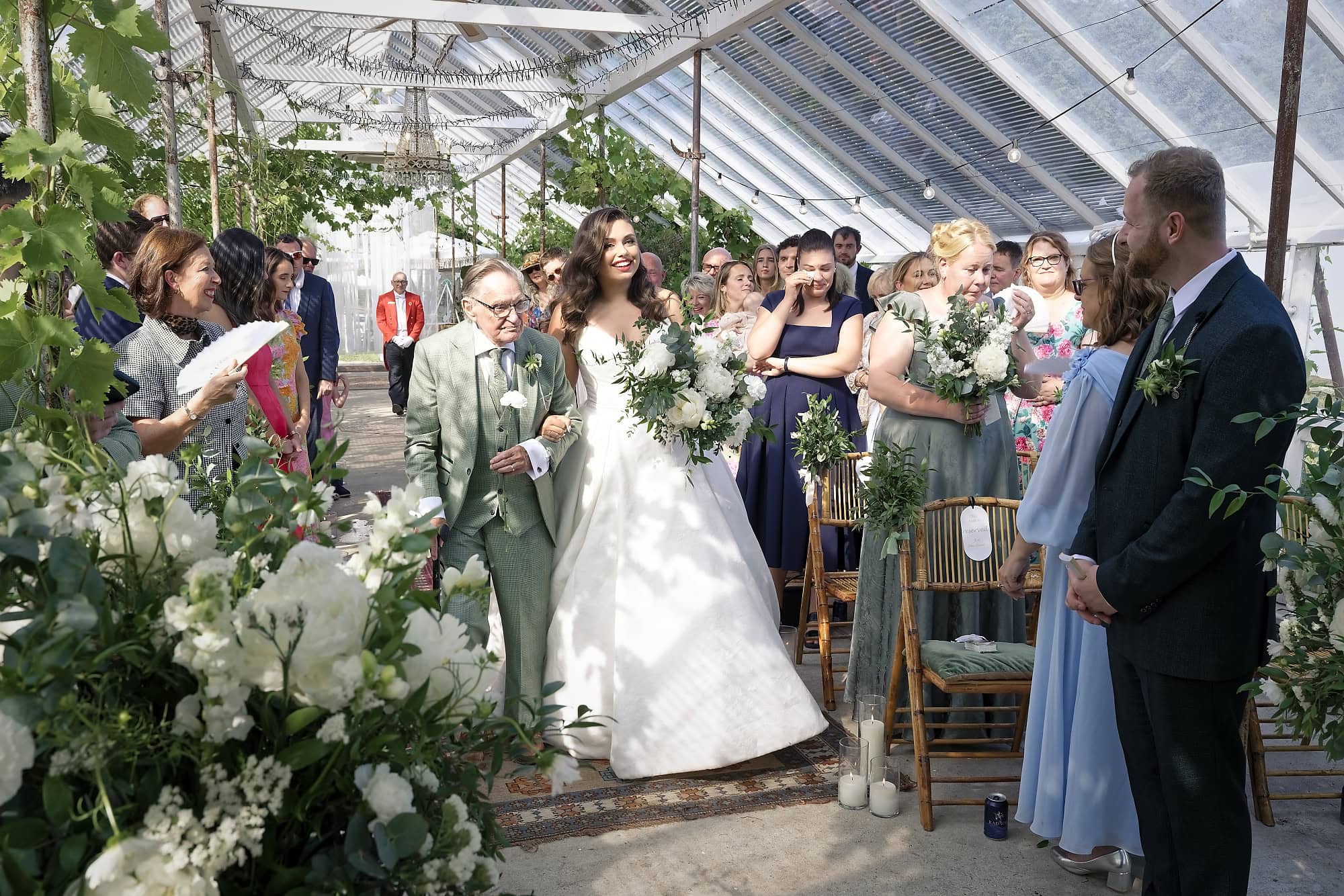 Bride with her grandad seeing her groom for the first time inside the Gooseberry House glasshouse