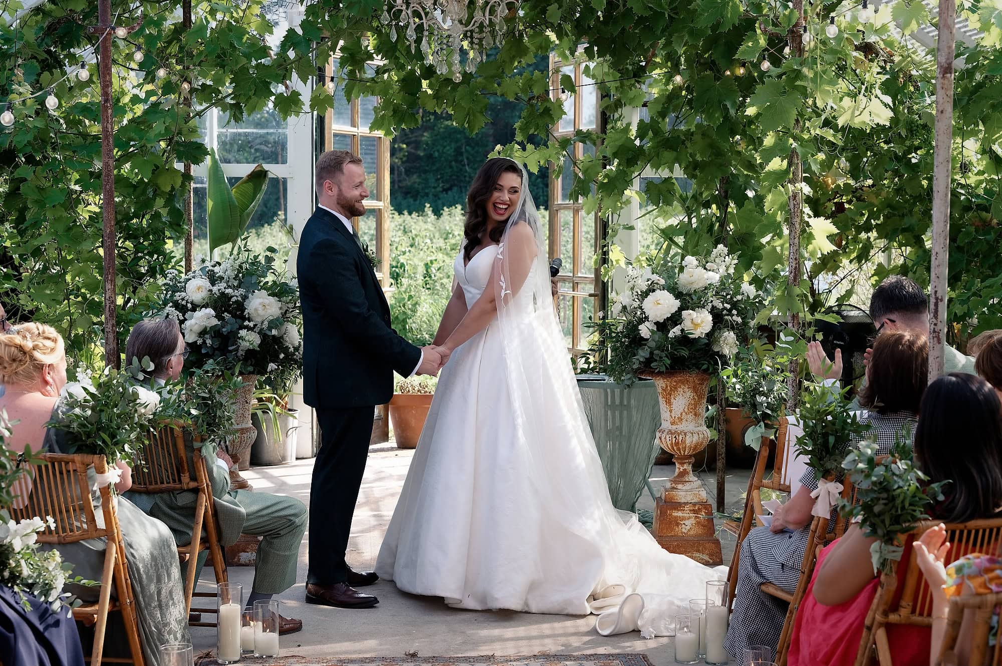 Bride and groom laughing together during the ceremony