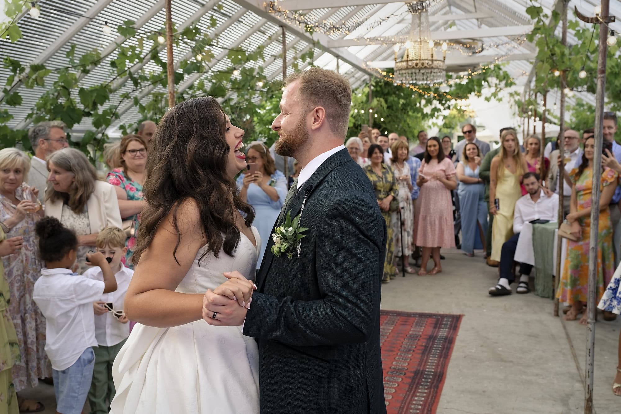 Bride laughing with her groom during their first dance