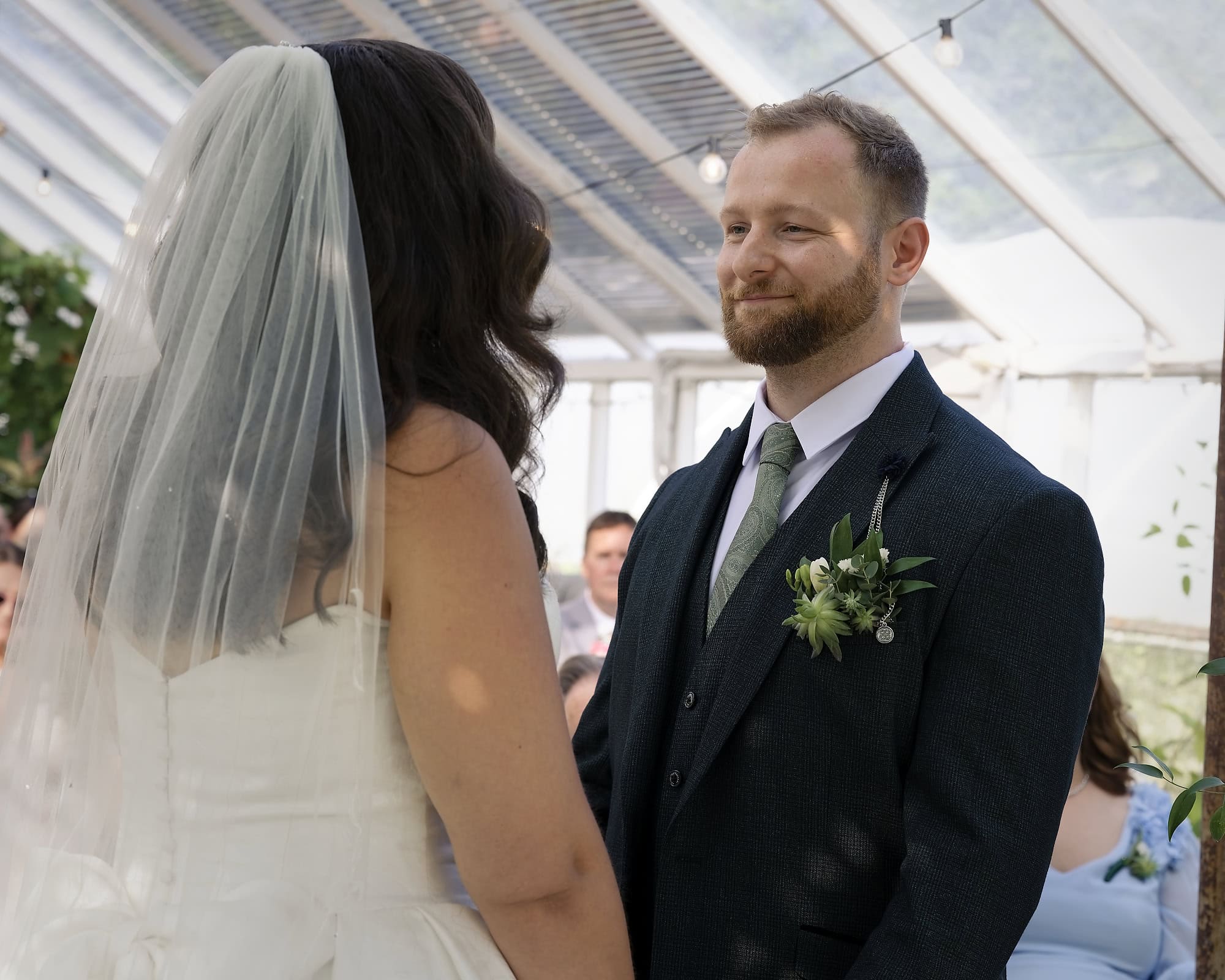Groom looking lovingly at his bride during the wedding ceremony