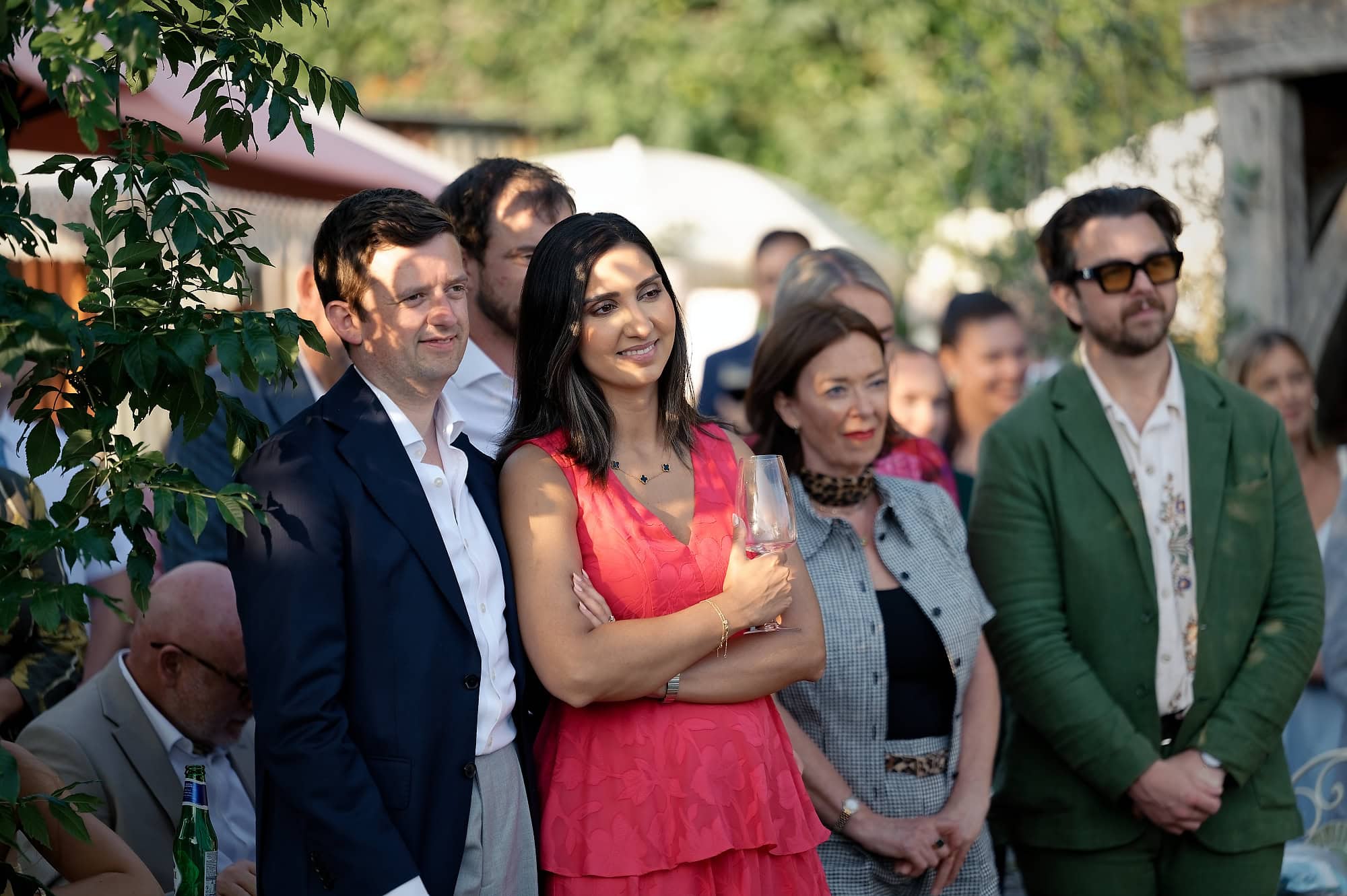 Wedding guests listening to speeches in the evening light