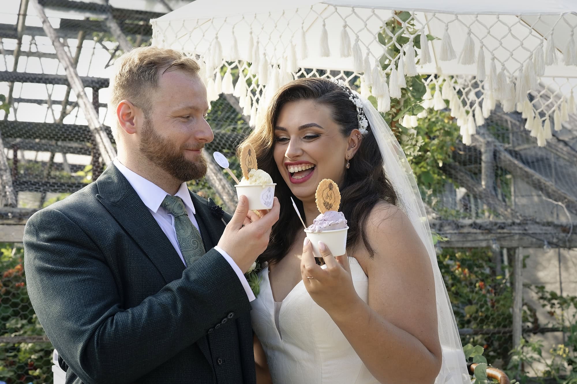 Bride and groom enjoying ice cream from the wedding's ice cream tricycle
