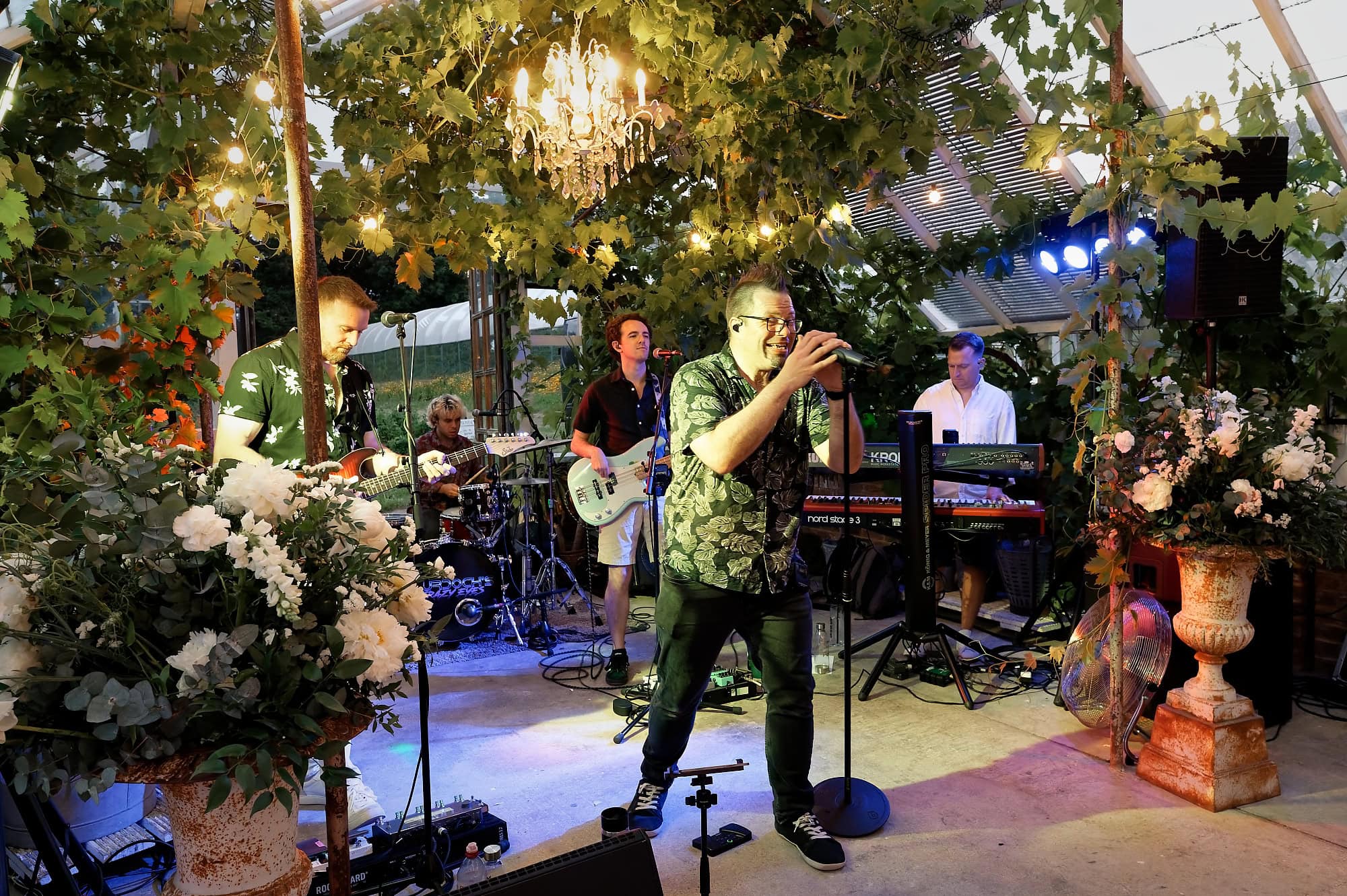 The wedding band performing live music into the evening