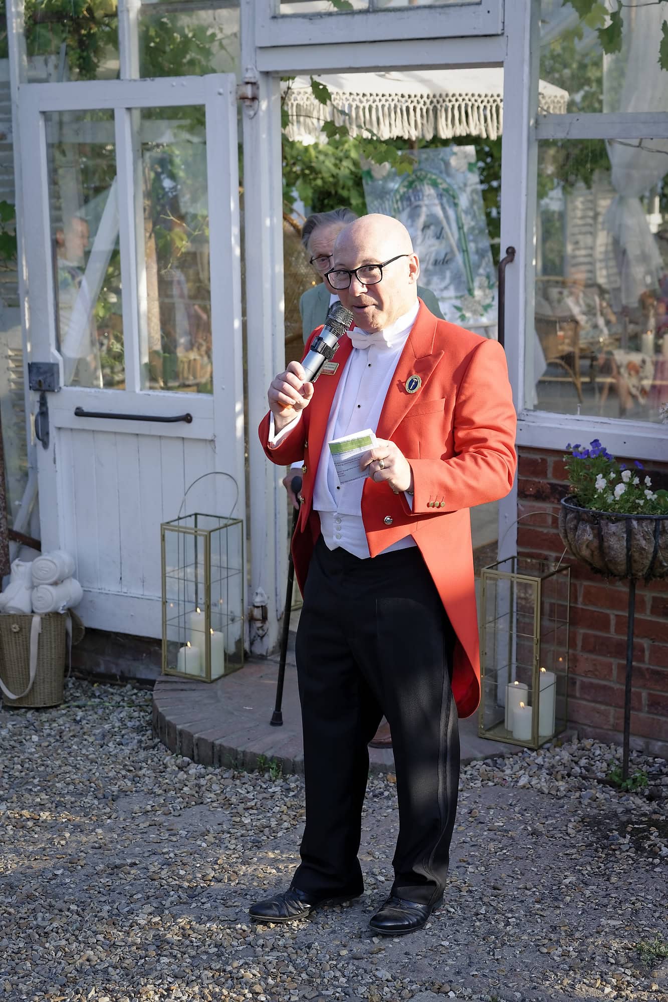 Toastmaster in a red tailcoat announcing speeches outside Gooseberry House