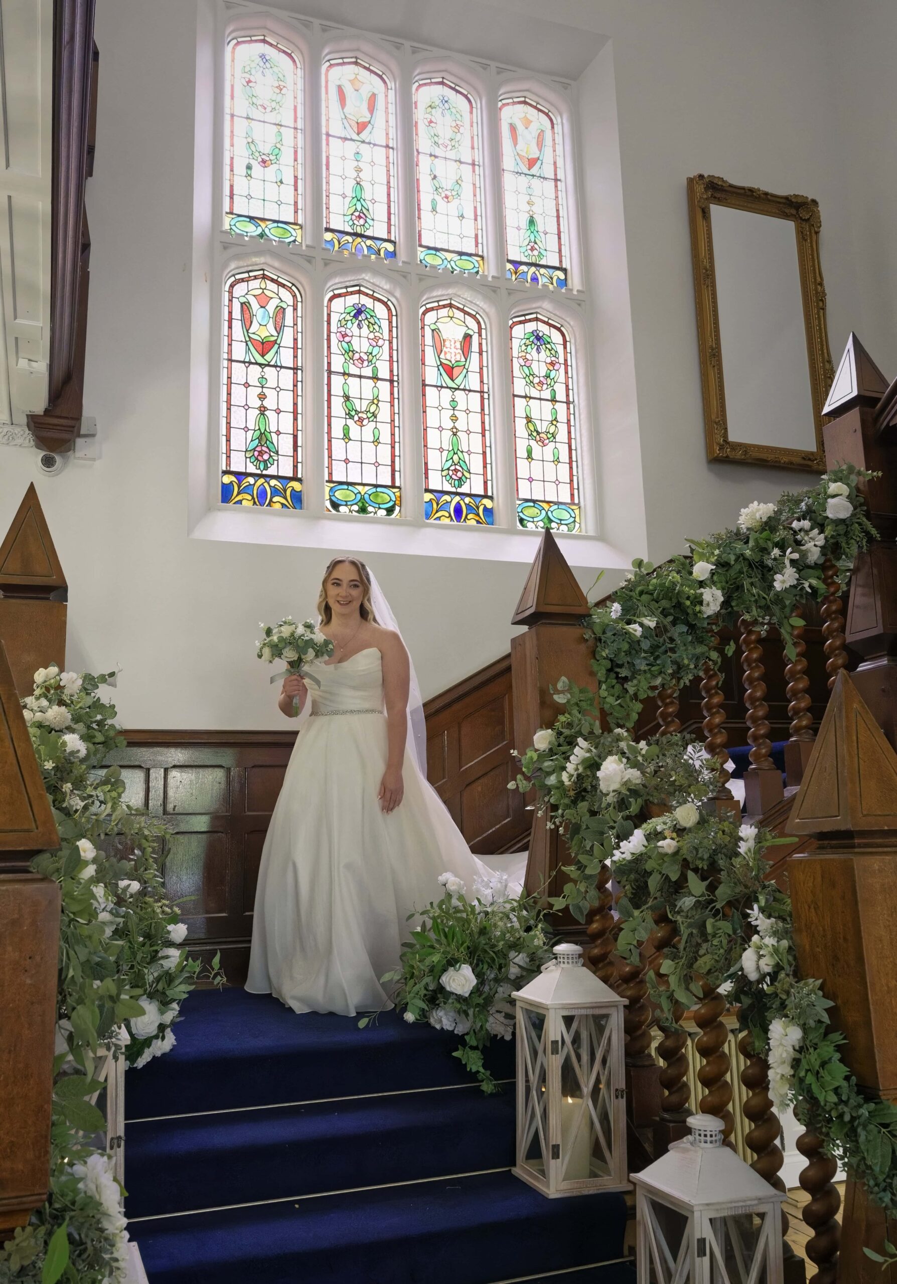 Bride descending the stained-glass staircase at Highley Manor ready for her ceremony