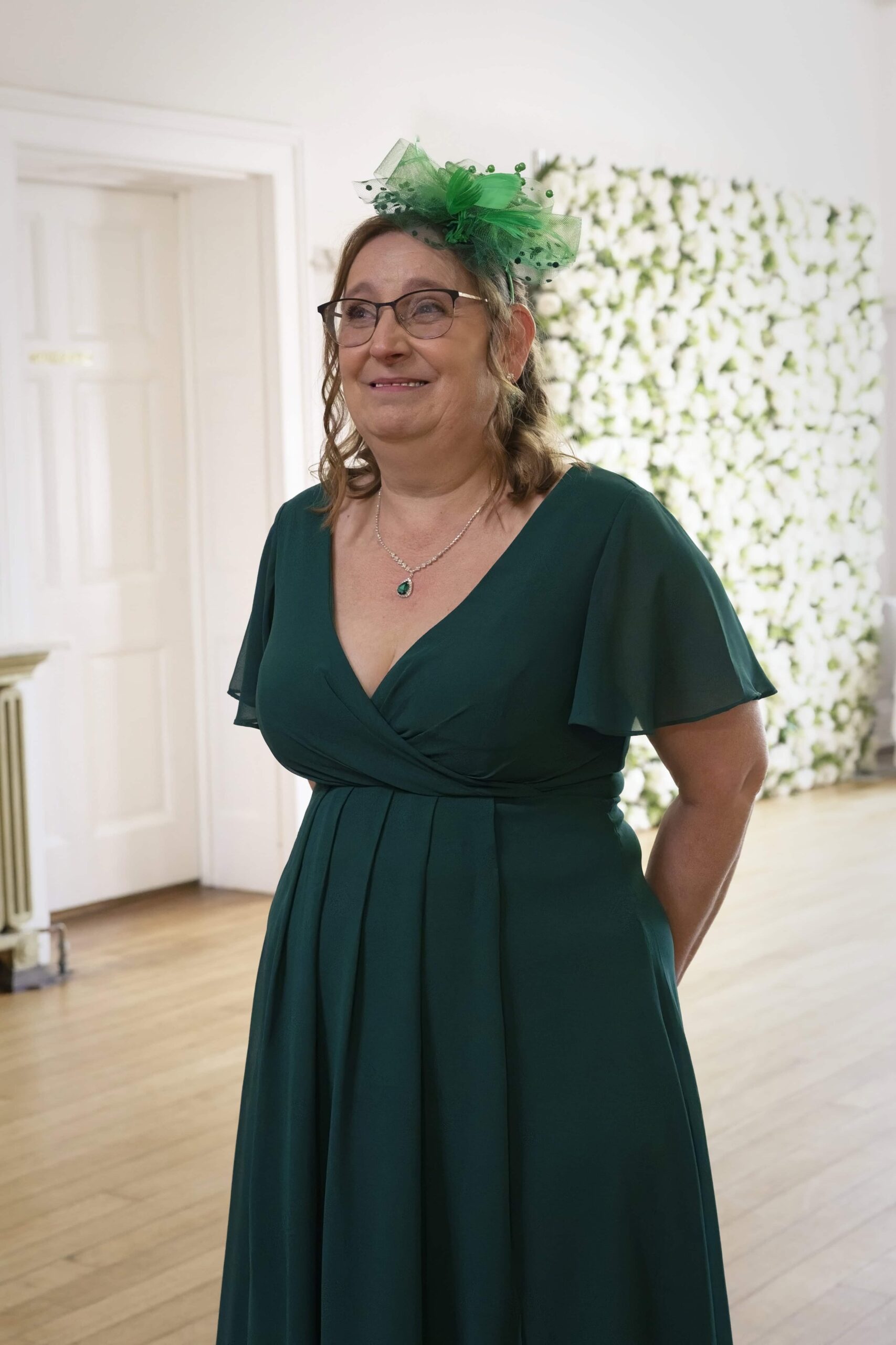 Mother of the bride in emerald green before the ceremony at Highley Manor