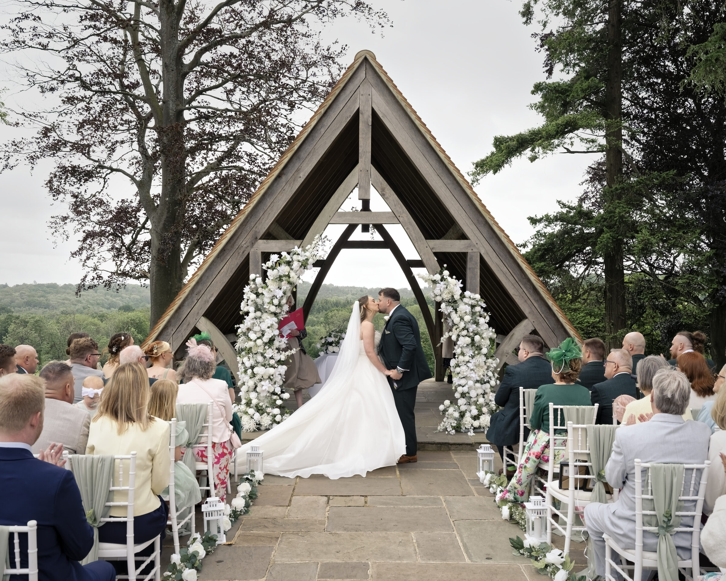 Bride and groom kissing during their outdoor ceremony at the Highley Manor pavilion