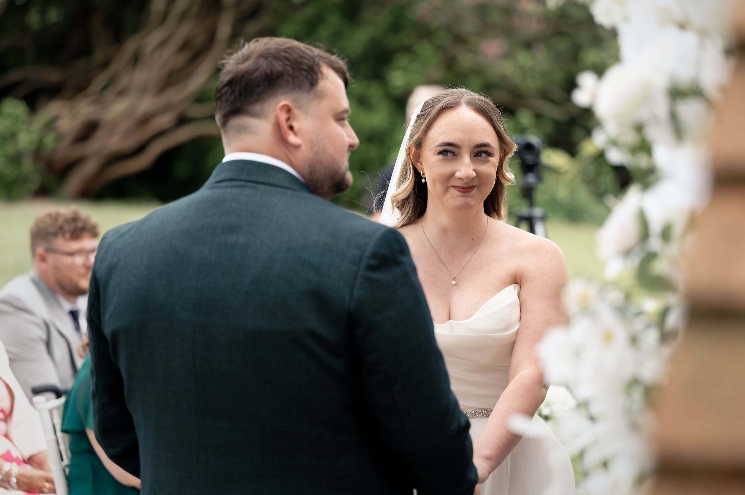 Bride and groom exchanging vows during their outdoor ceremony at Highley Manor