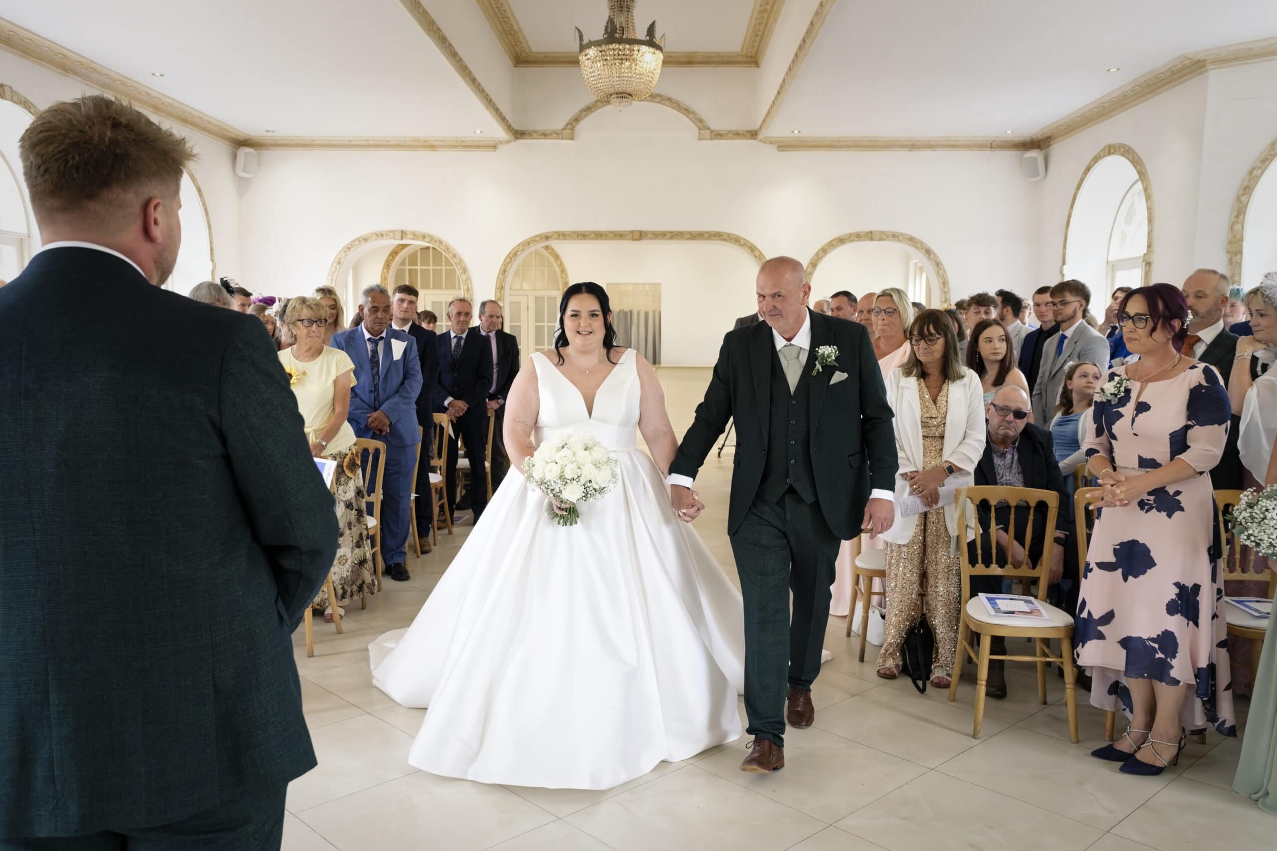 Bride walking down the aisle with her dad at Northbrook Park