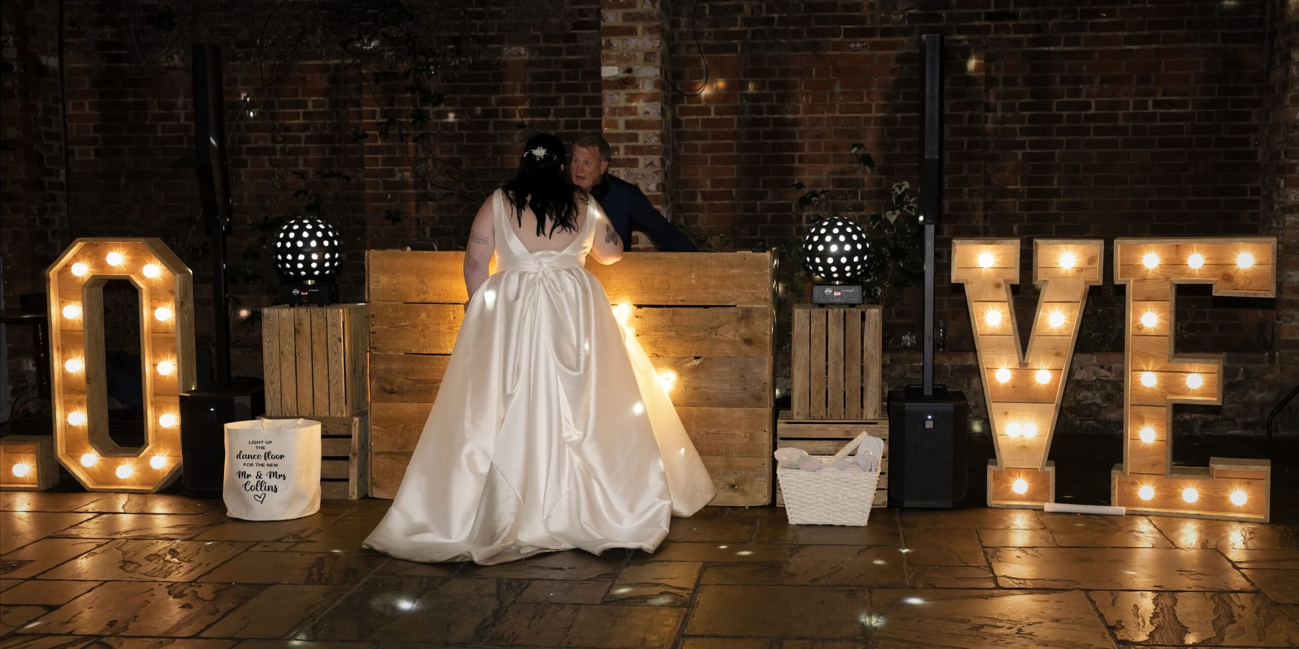 Bride beside the light-up LOVE letters