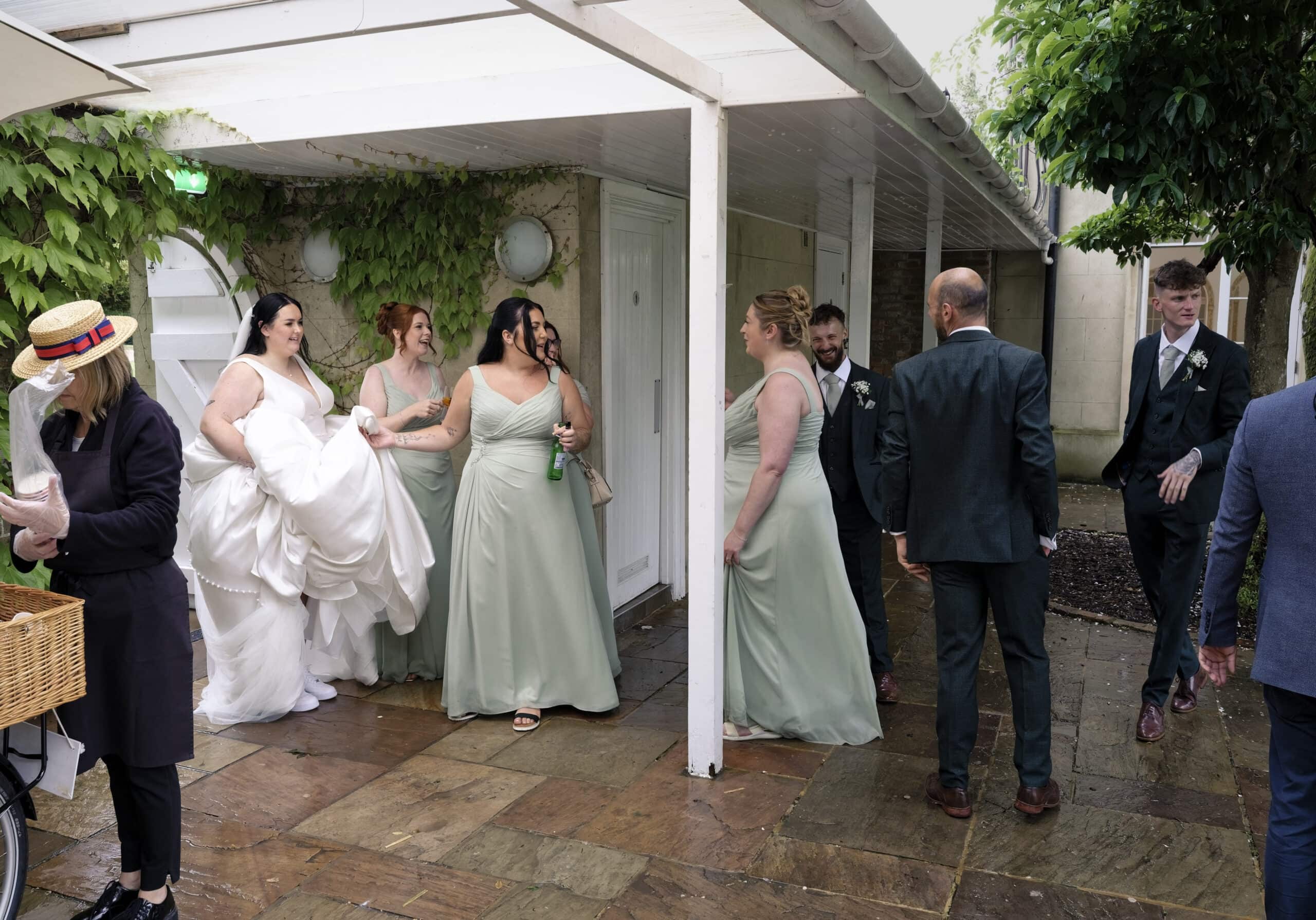 Bride and bridesmaids heading off to sort out a mark on the dress after the wedding breakfast