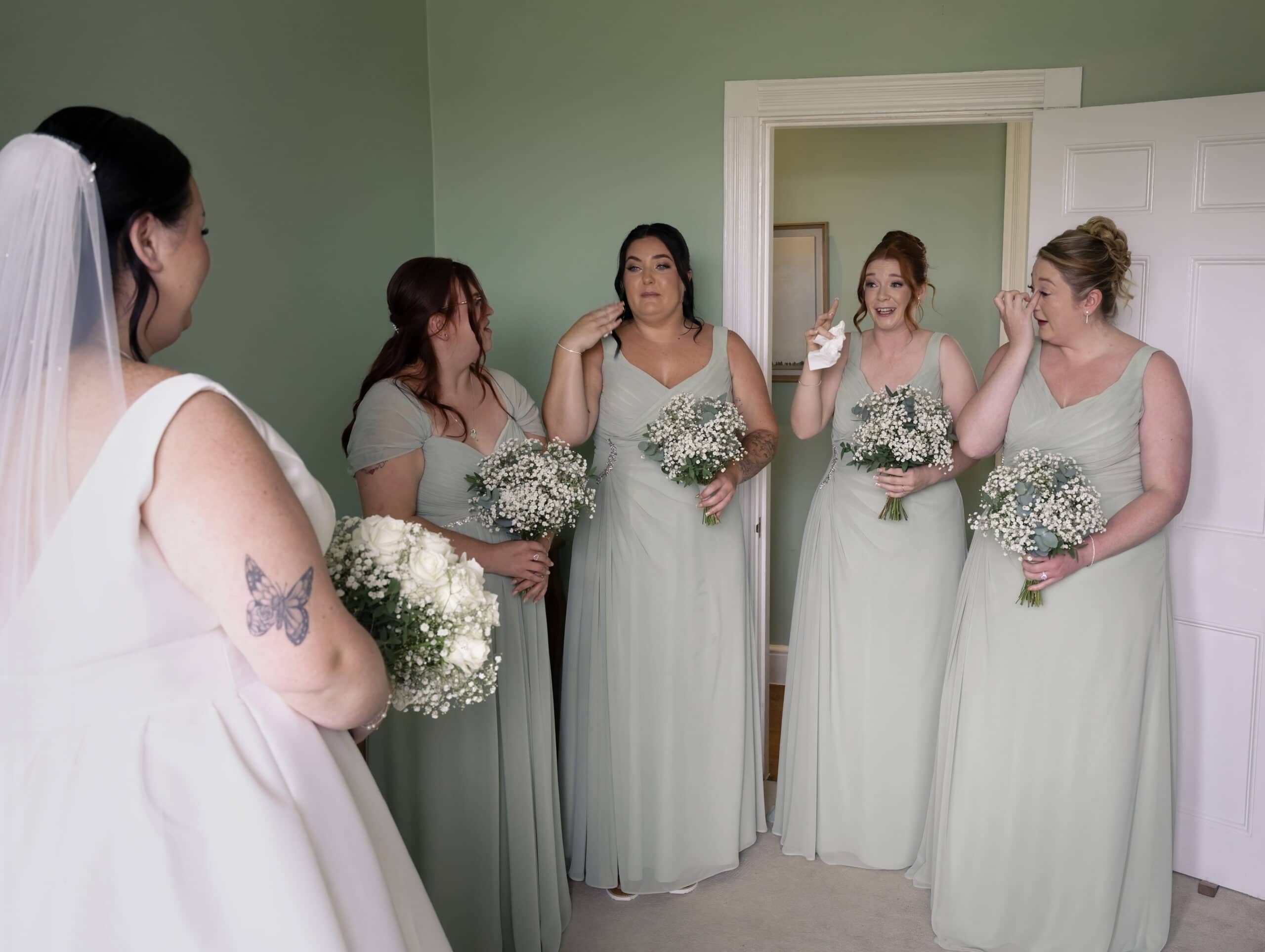 Bridesmaids sharing an emotional moment with the bride