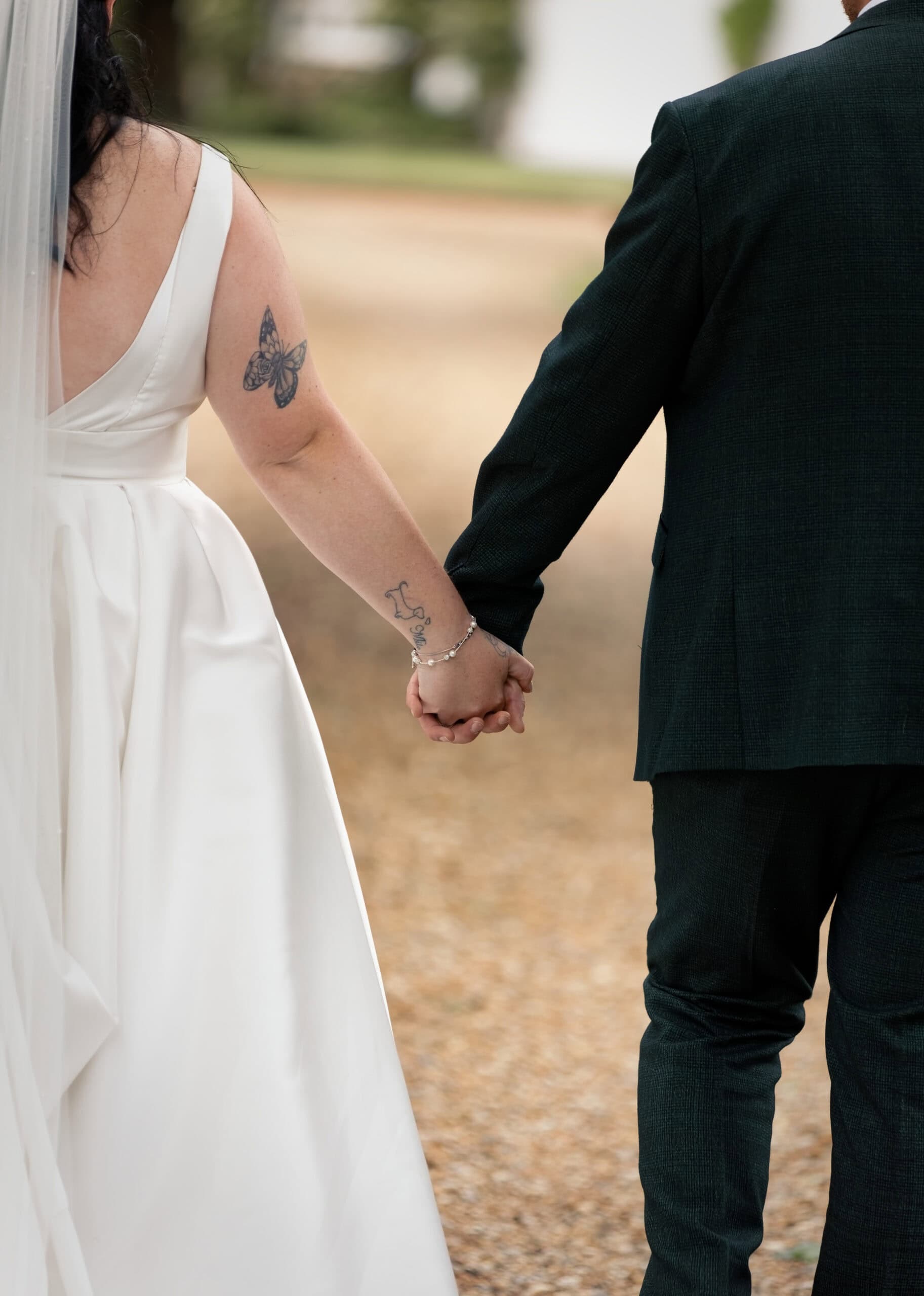 Bride and groom holding hands while walking