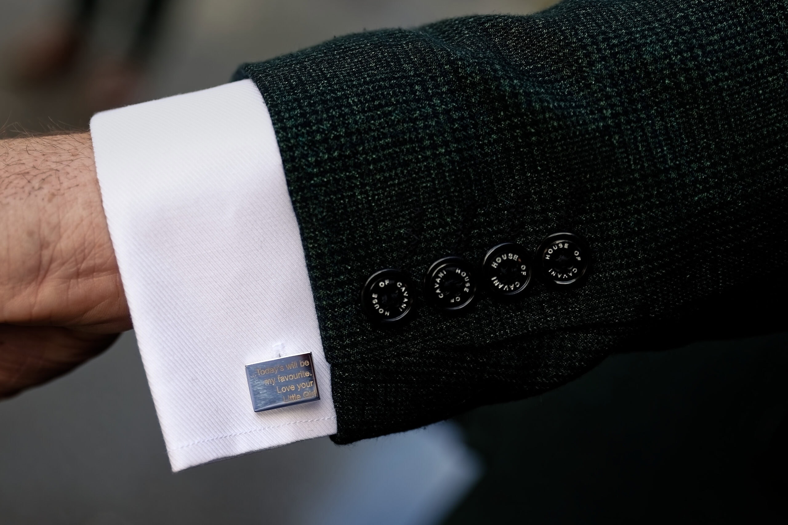 Close-up of the groom's cufflink and jacket sleeve