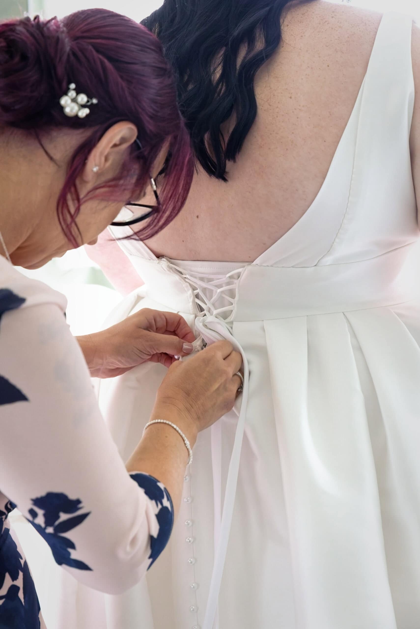 Detail of the wedding dress being laced up