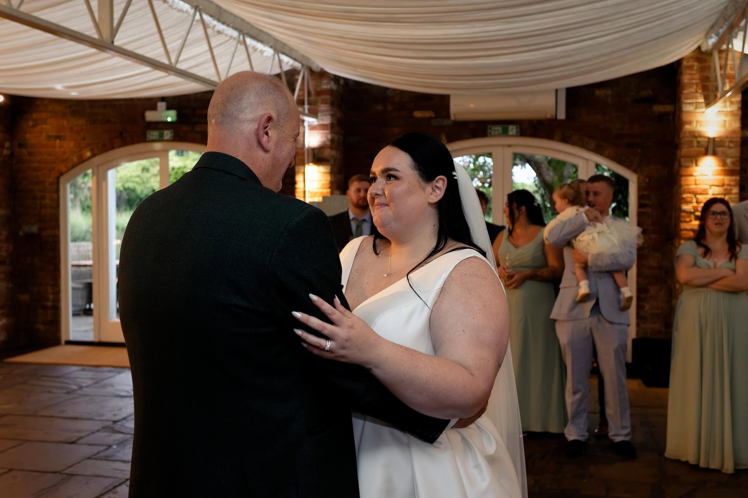 Father and daughter dance during the evening reception