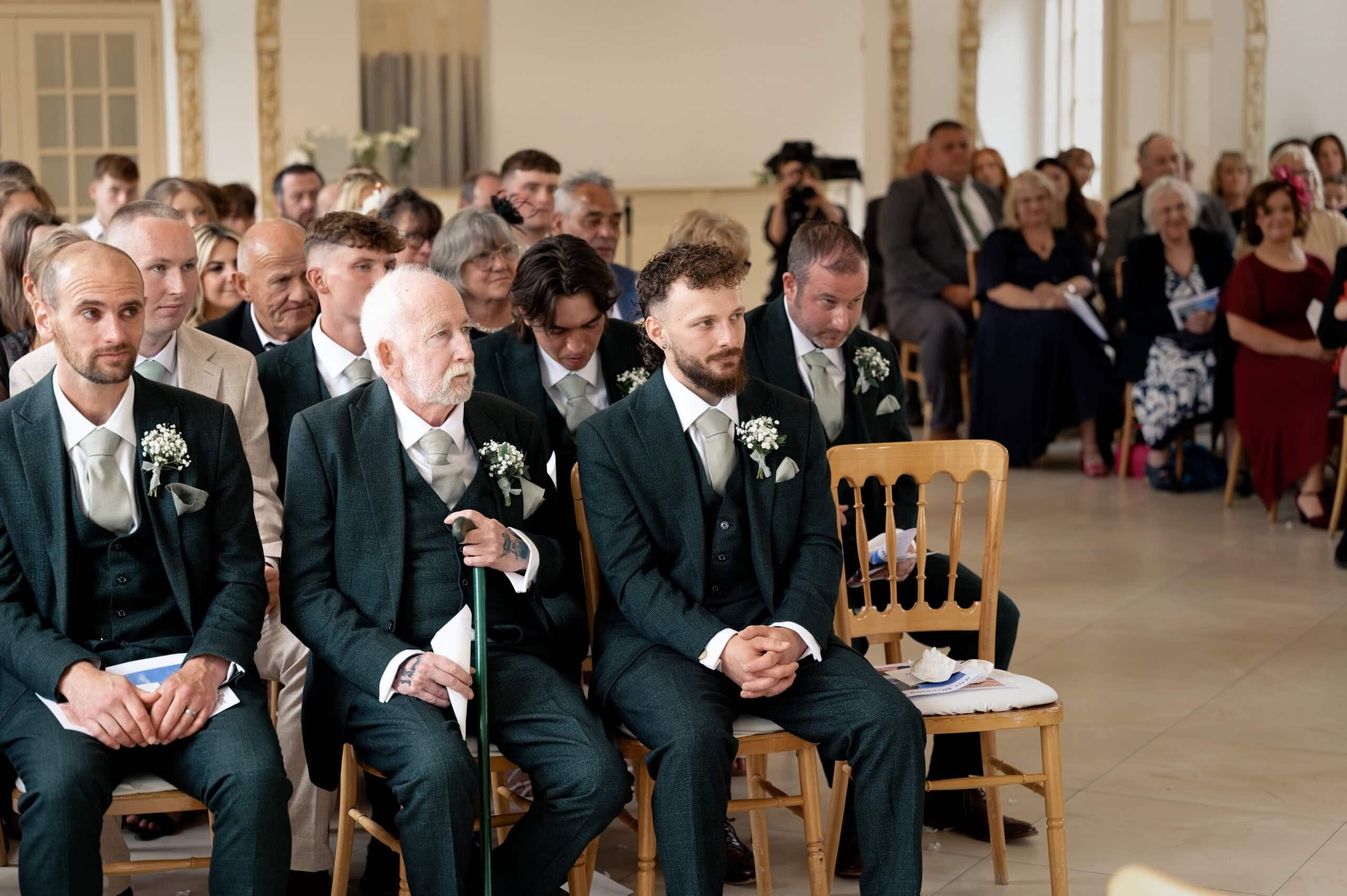 Groomsmen seated ahead of the ceremony