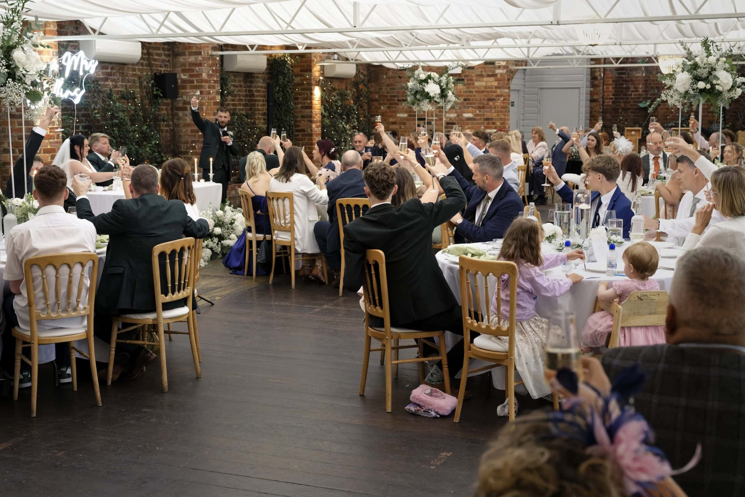 Guests applauding during the wedding breakfast